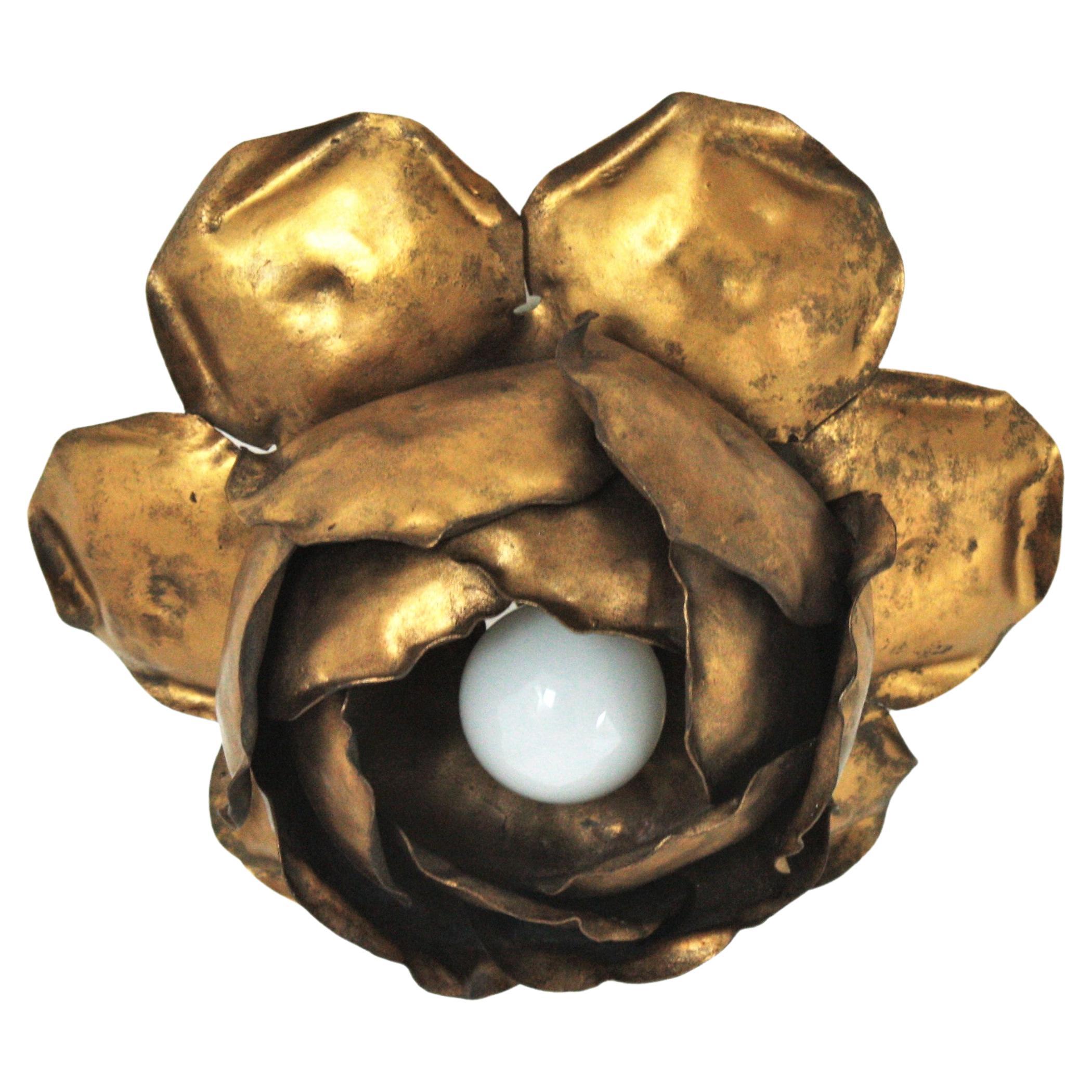 Flower shaped flush mount, gold leaf, gilt iron. Spain, 1950s.
Eye-catching ceiling light fixture in the shape of a peony flower bud.
This hand- wrought iron ceiling light fixture is nicely constructed, with leaves surrounding the central light. It