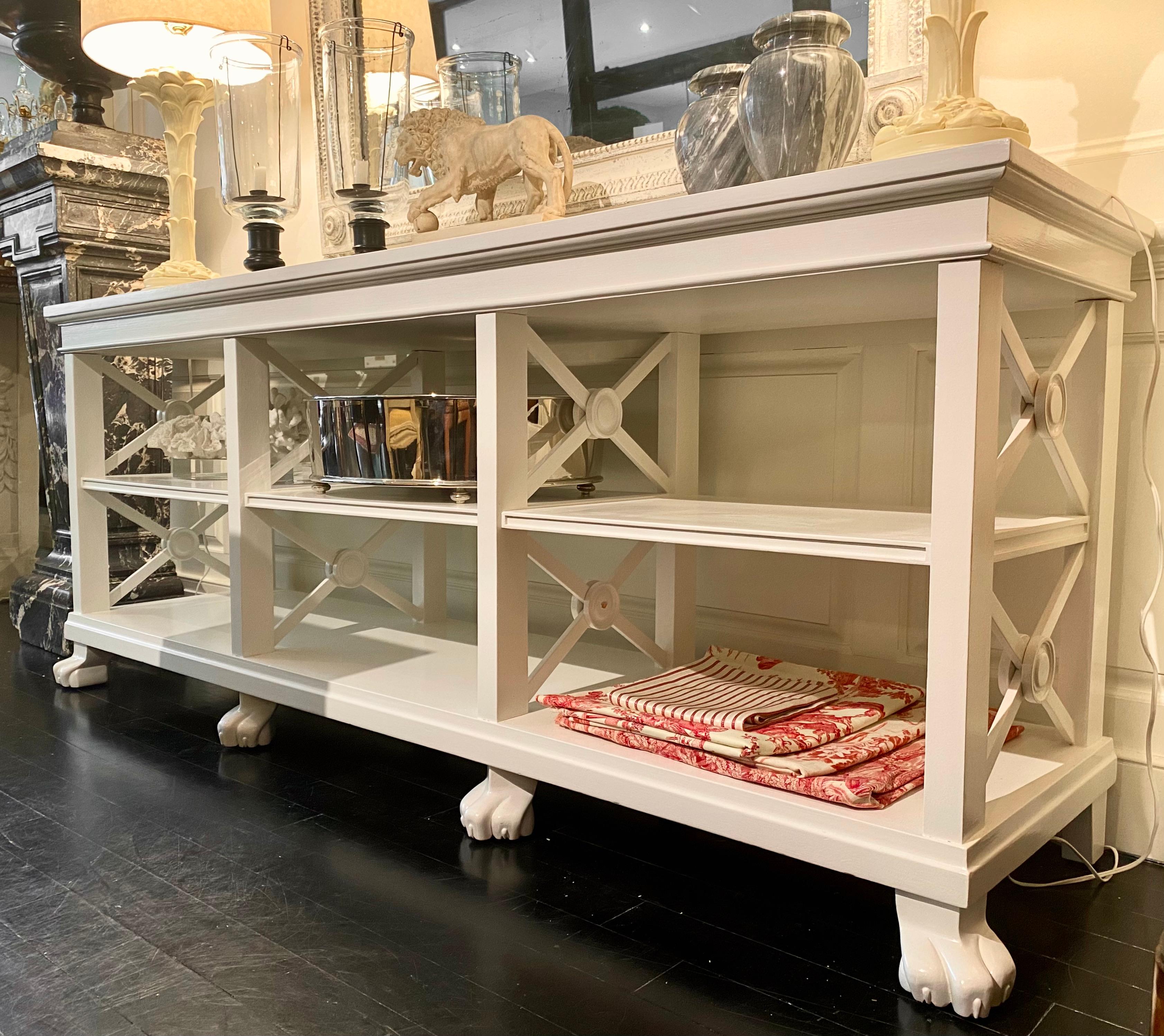 French large Neoclassical bookcase, painted in white lacquer, lion's claw feet, neoclassical x or cross design at ends.