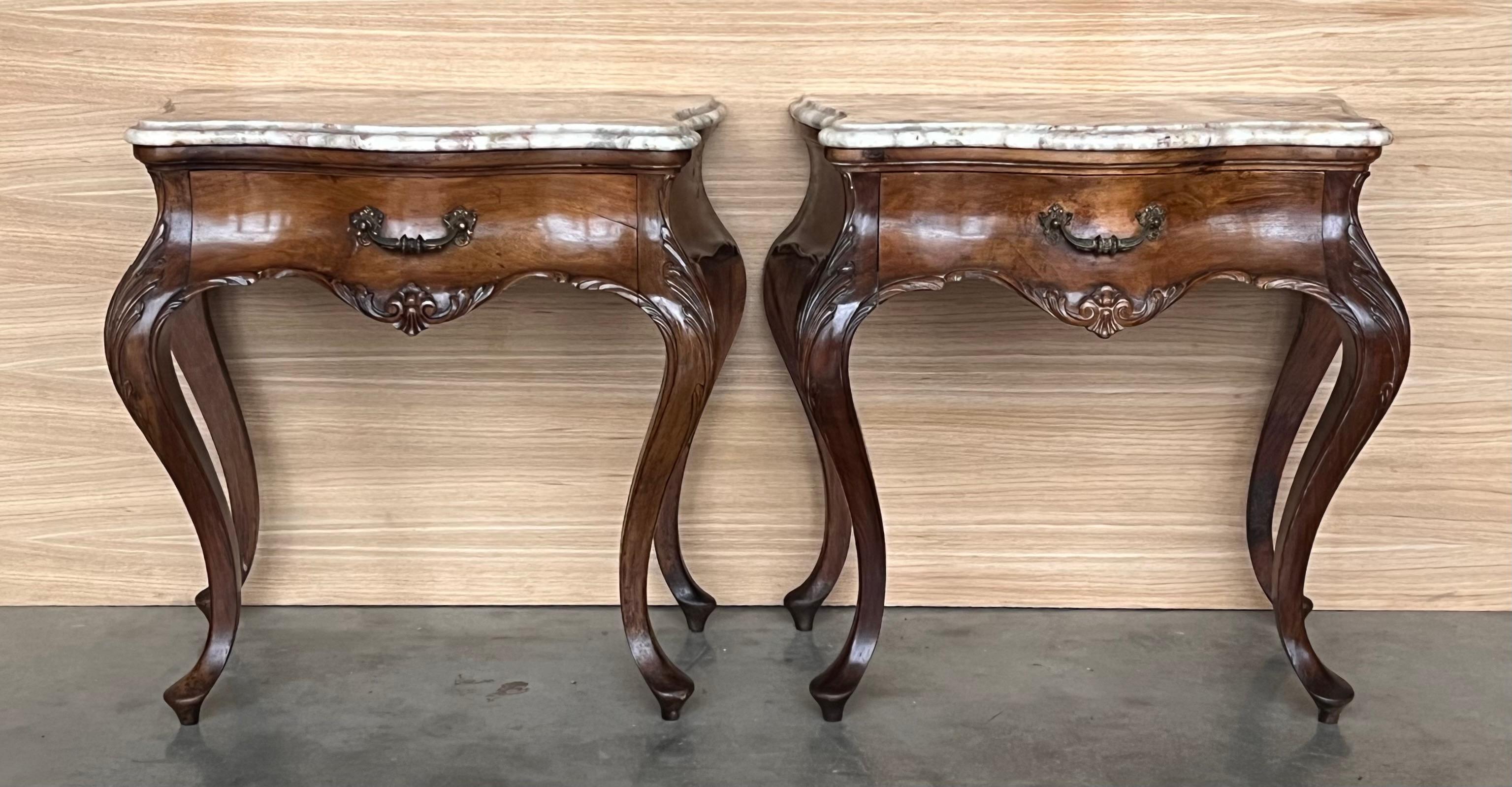 Pair of French bedside tables from the early 20th century with beautiful beveled marble top, drawer with bronze handle and cabriole legs. The tables have a beautiful carving on the legs and a very nice skirt on the front.
We have cleaned, waxed and