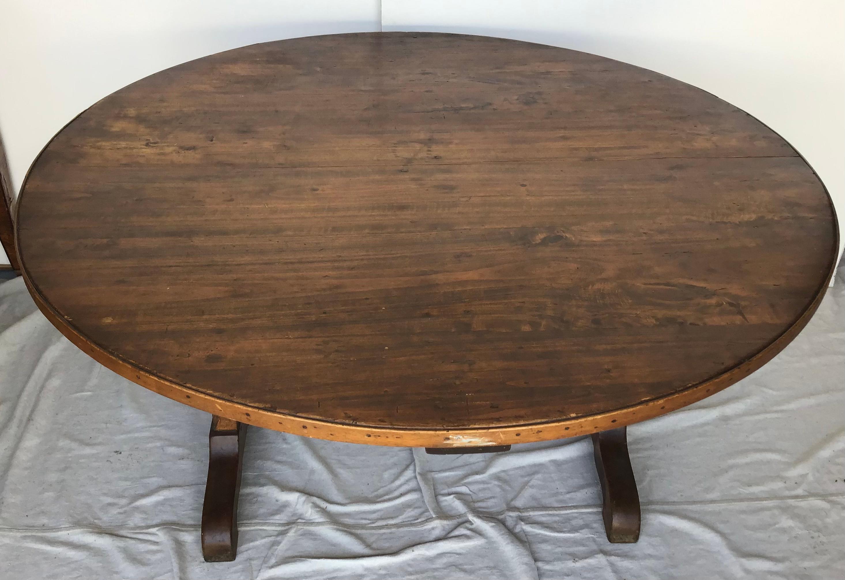 A very grand scale Table Vigneron - Wine Tasting Table from the South of France. Beautifully constructed from walnut in a round shape and tilting top. Terrific as a breakfast table or dining table. Great patina.