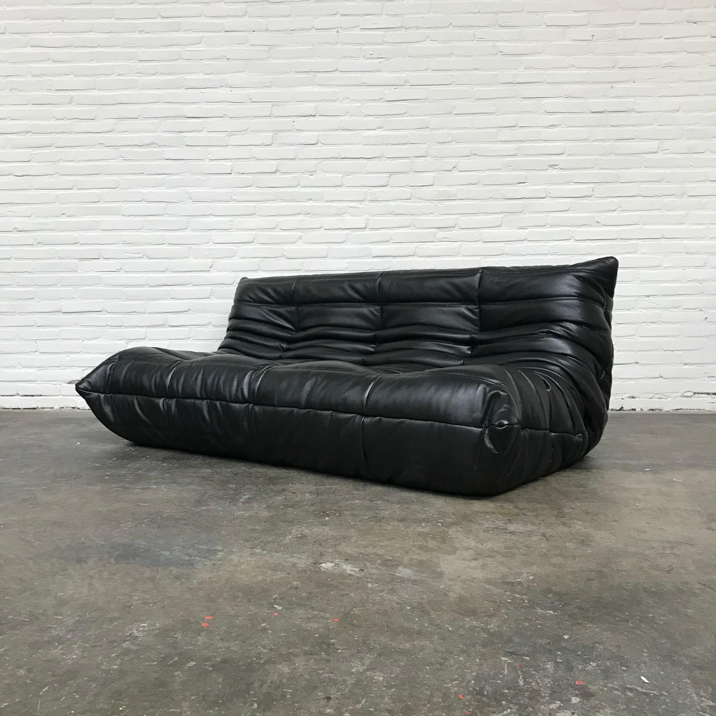 The Togo is designed by Michel Ducaroy in 1973 for Ligne Roset in 1973 but is still very popular today. This Togo is refurbished. Weak parts of foam have been replaced by firm new ones. Thereafter the sofa is reuphostered in Fine Italian black