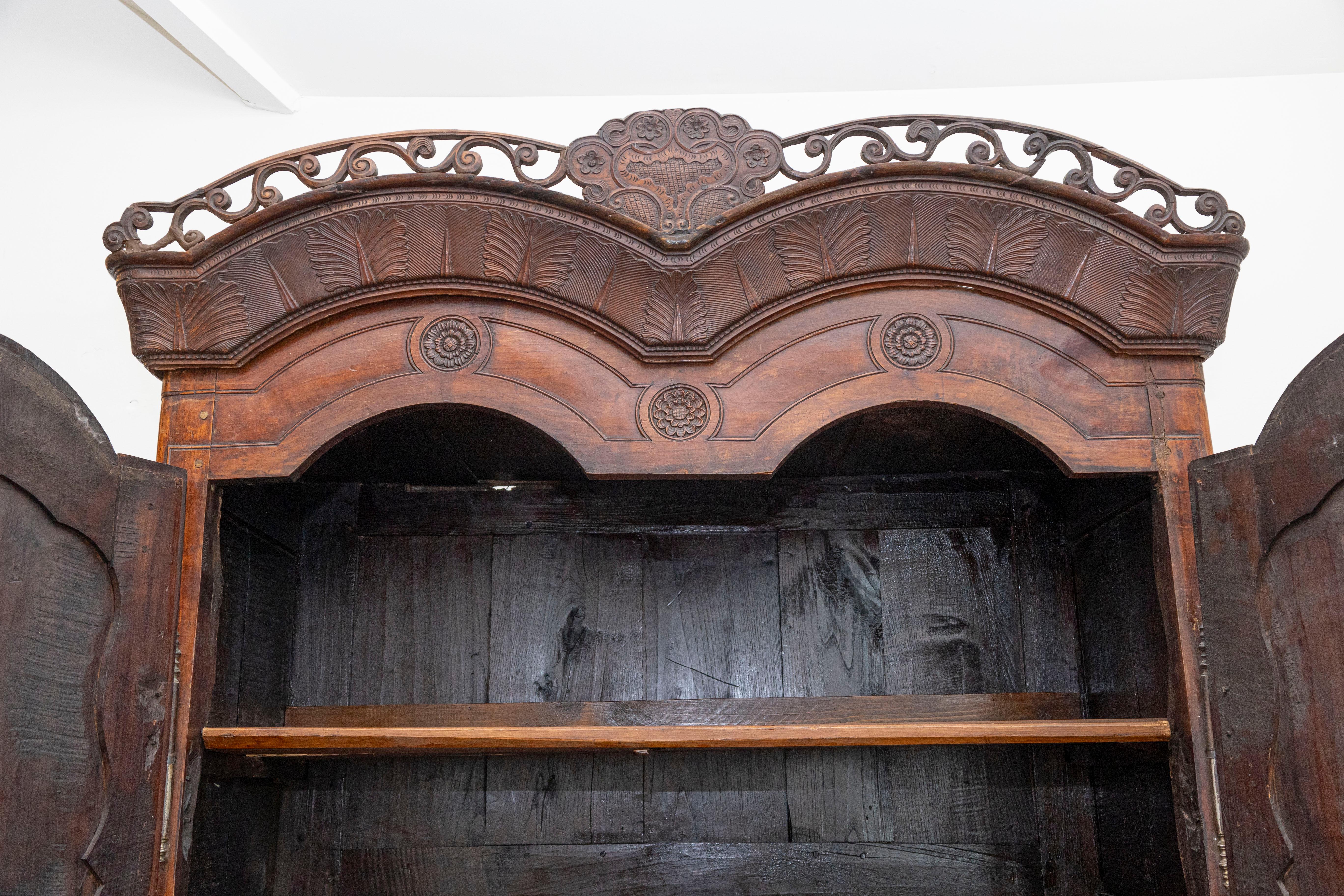 French Late 18th Century Cherry Armoire from Rennes with Hand Carved Décor In Good Condition In Atlanta, GA