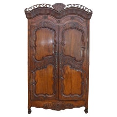 French Late 18th Century Cherry Armoire from Rennes with Hand Carved Décor