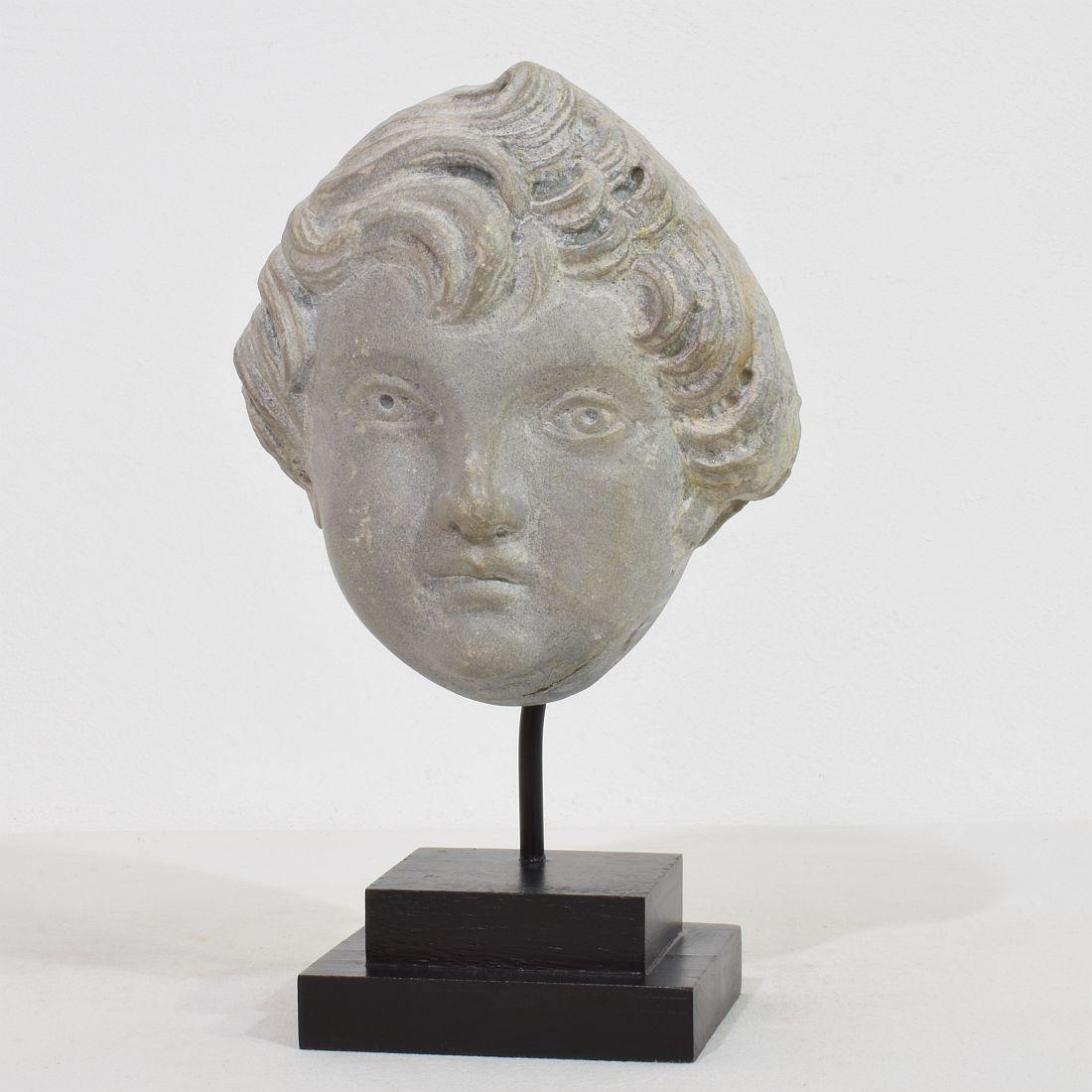 Unique and wonderful hand carved grey marble angel head, France, circa 1780-1800. Beautiful weathered.
Measurement includes the wooden base.