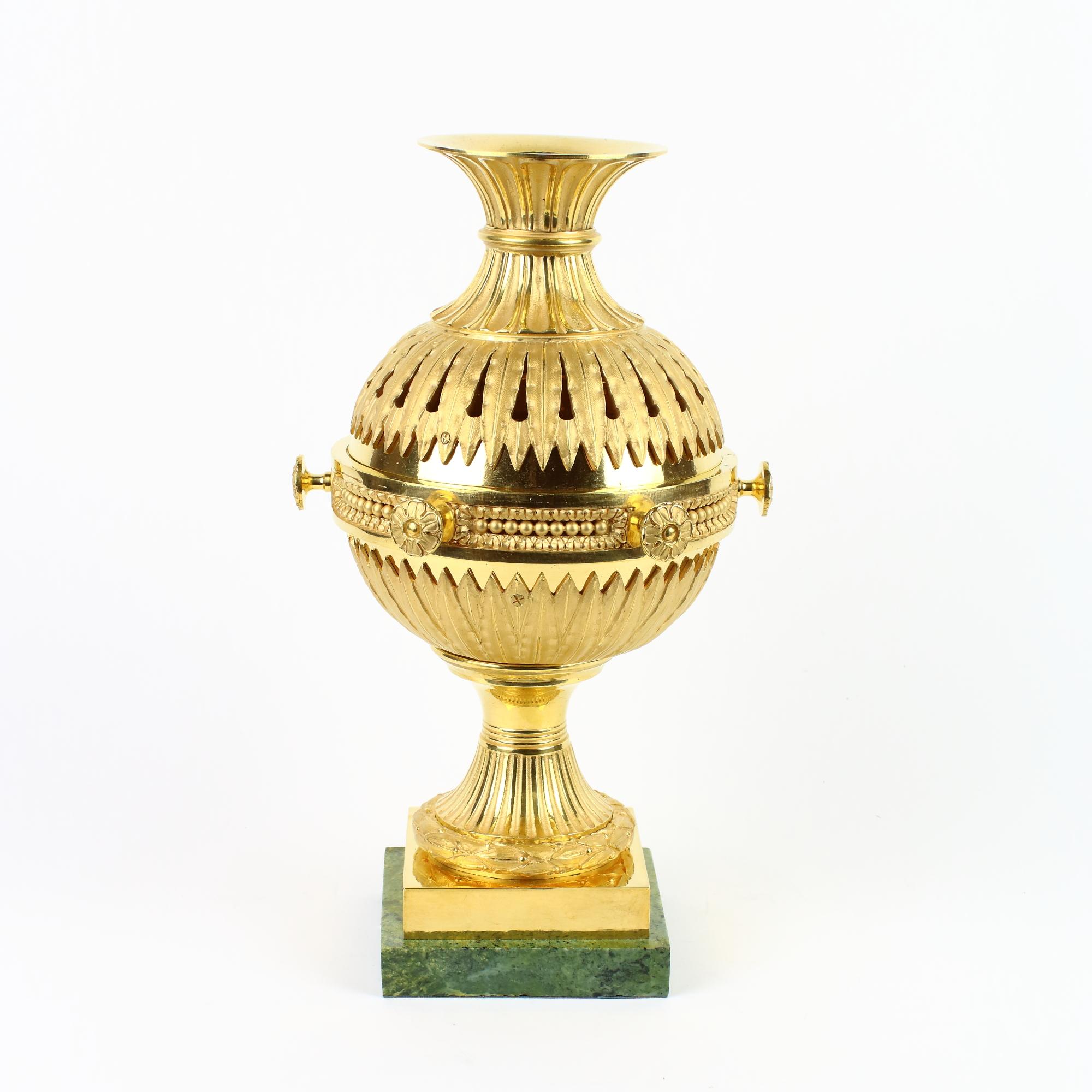 French Late 18th Century Louis XVI Gilt Bronze Incense Burner or Brule Parfum

A round and fluted foot surrounded by a laurel wreath standing on gilt bronze rectangular plinth which is mounted on a green marbled metal base. The round foot carries