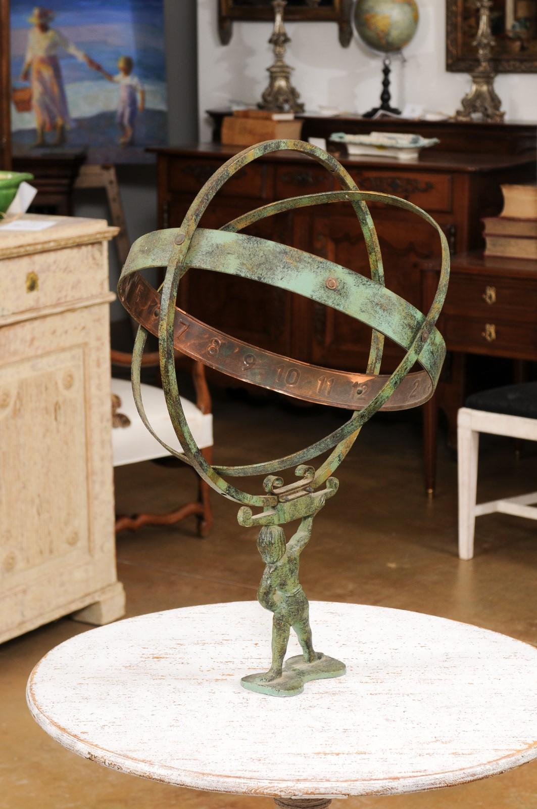 A French bronze armillary sphere depicting Atlas carrying the world from the late 19th century with verdigris patina. Created in France during the last quarter of the 19th century, this bronze armillary sphere showcases a mythological theme