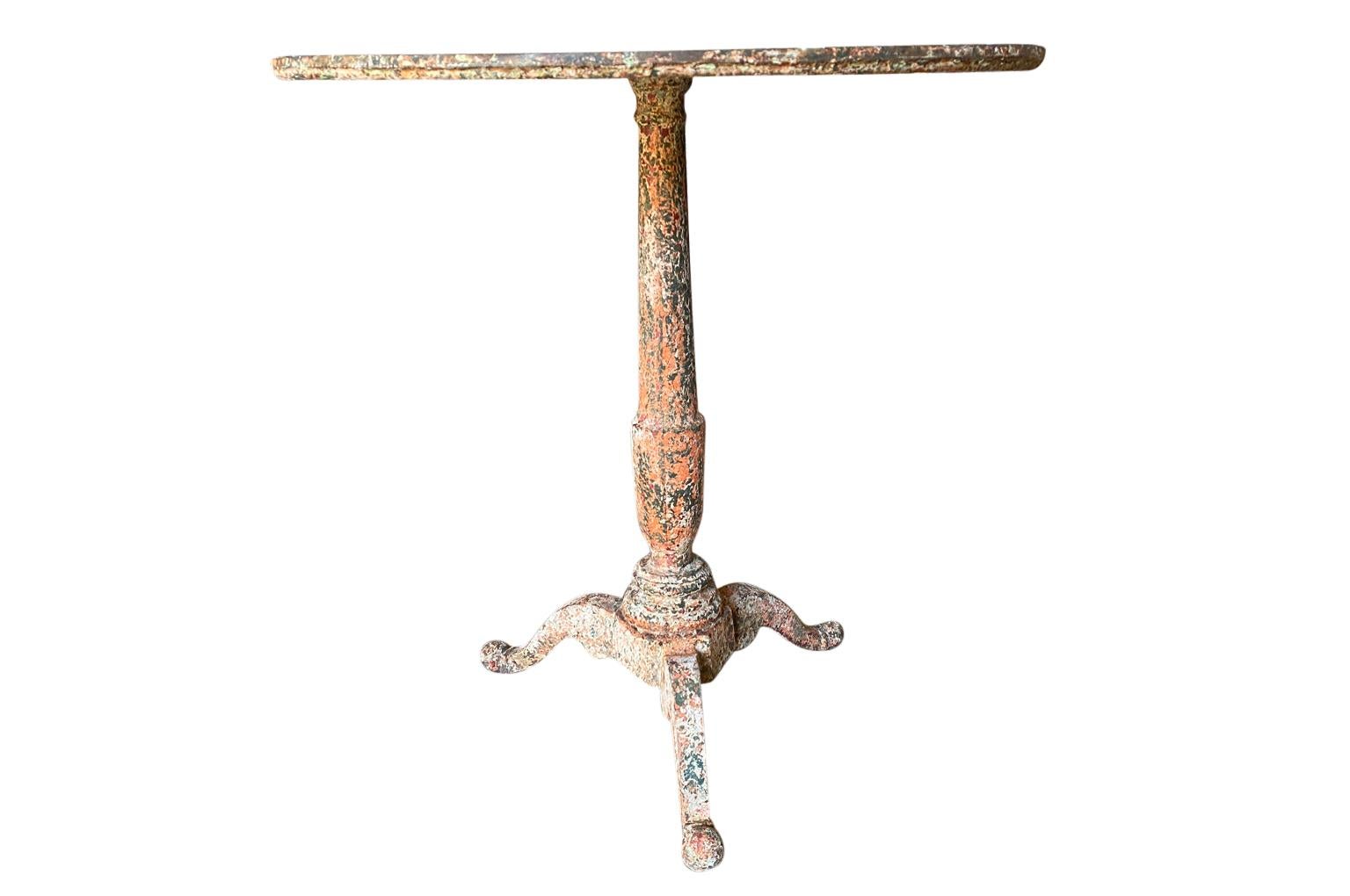 Late 19th century garden gueridon from the Provence region of France. Soundly crafted from weighty cast iron with a fabulous painted finish. Great patina. Perfect for any interior of garden.