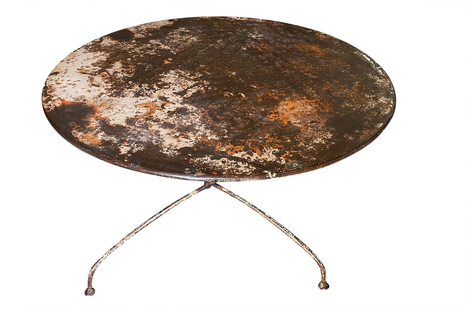 A very charming later 19th century Garden Table from the Provence region of France.  Soundly constructed from painted iron and is collapsible.  Super patina.  Perfect for any garden or interior.