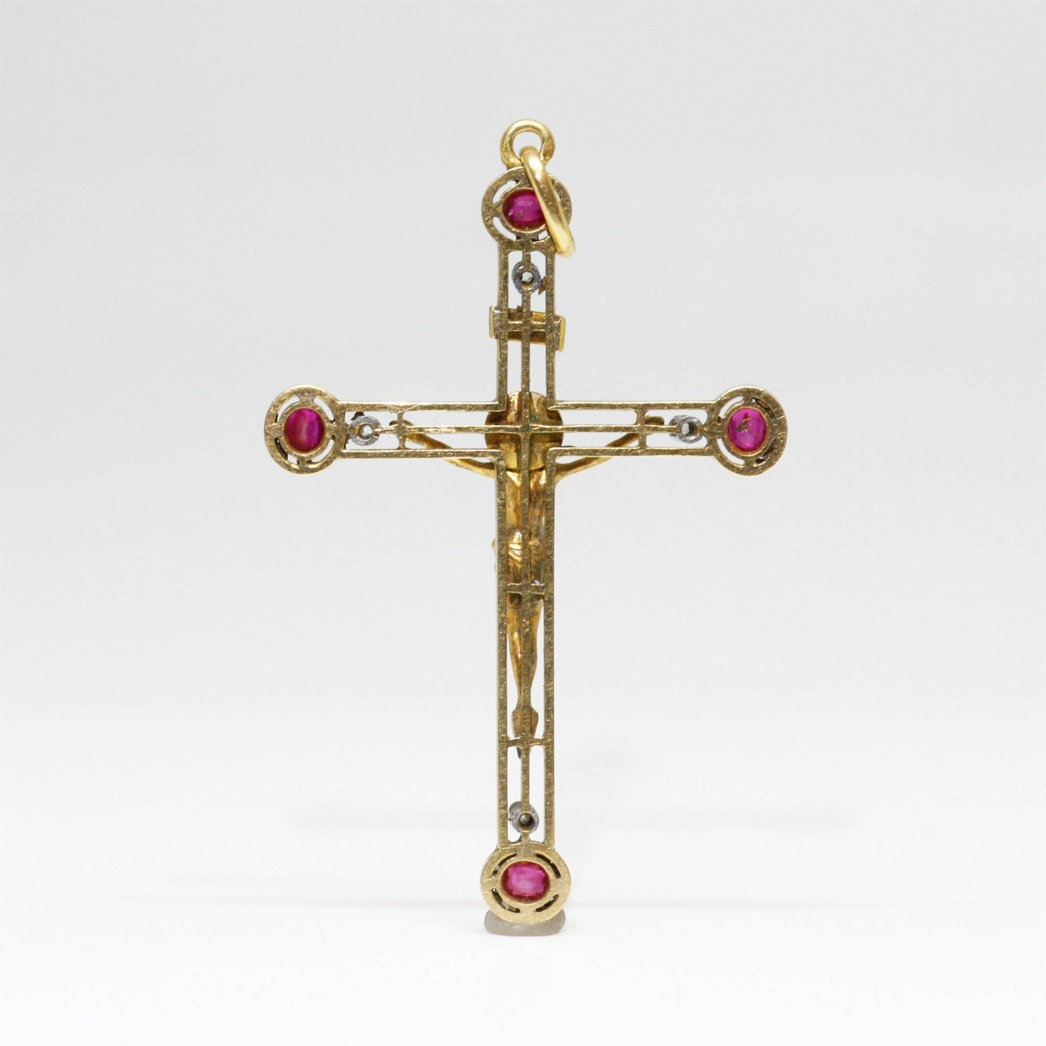 Yellow 18K gold crucifix cross with Jesus Christ. This beautiful cross is enhanced with 4 smalll rubies (raspberry color, probably of Burmese origine) and 4 tiny diamonds. 
Perfect condition.
French (hallmark : eagle’s head), circa 1900

Height : 54