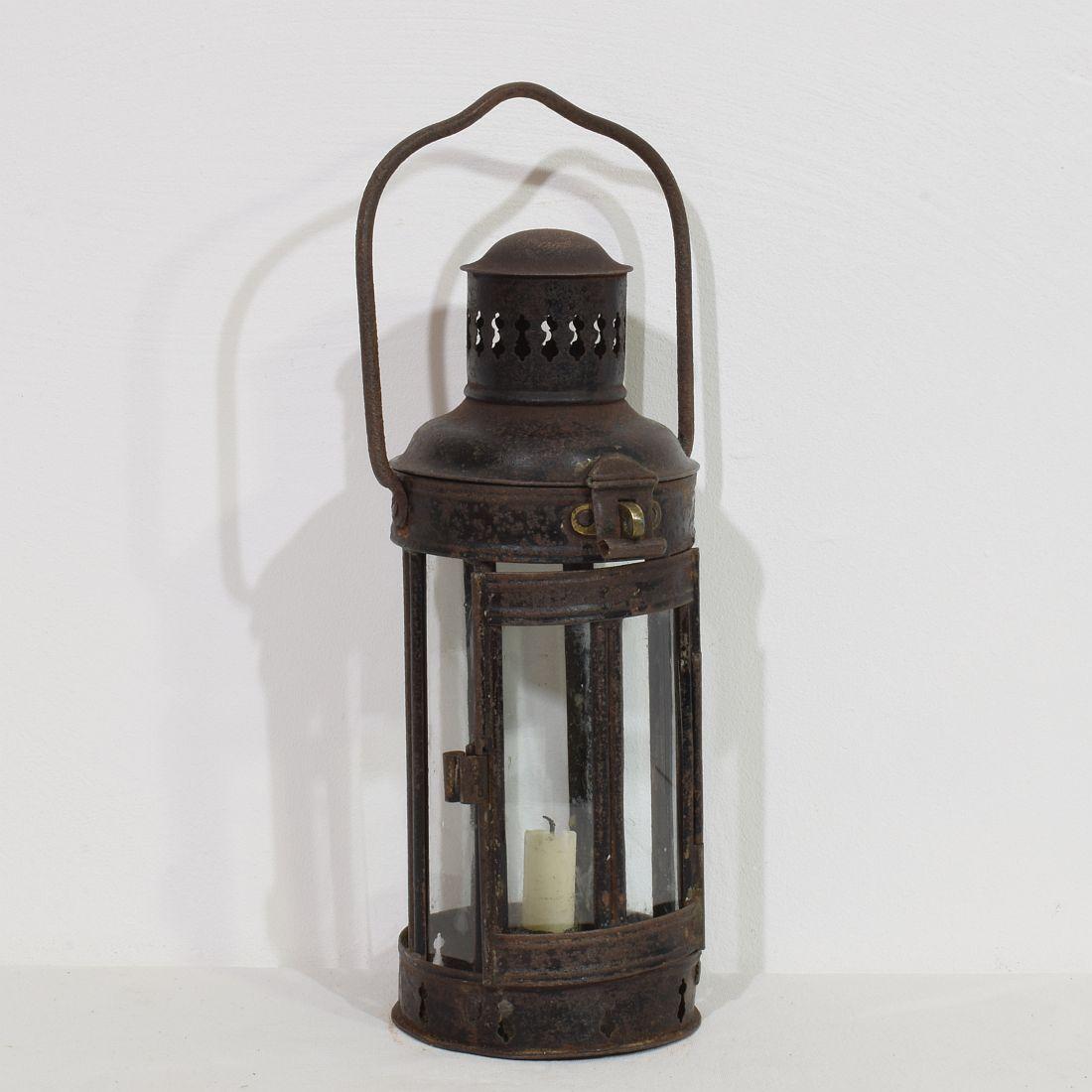 Really lovely metal lantern in a form I haven't seen before.
It can stand on its own or you can hang it.  France, circa 1890-1900. Weathered and old repairs. To my opinion glass of later date. H:32-37cm  W:14cm D:14,5cm 