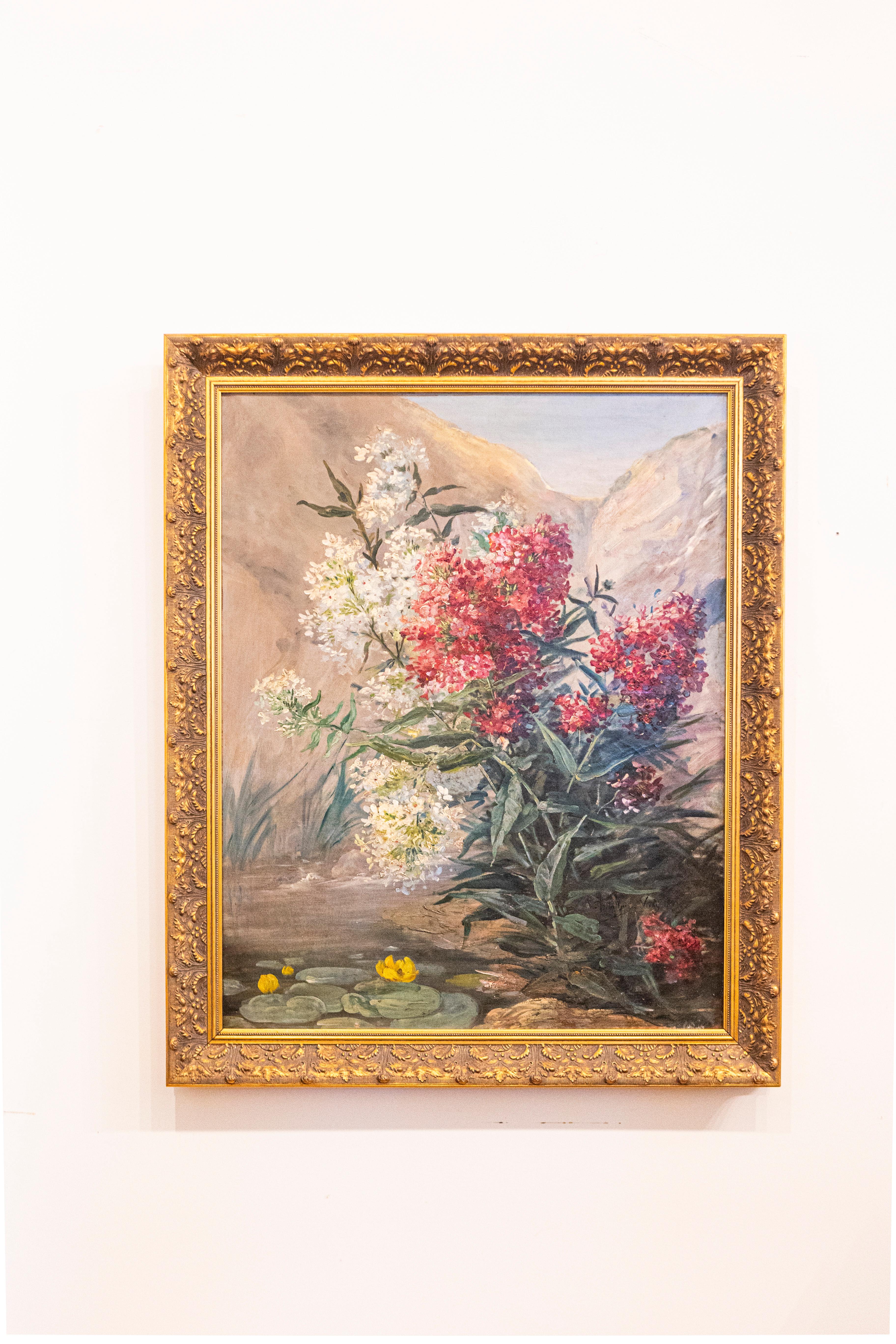 Une nature morte française encadrée à l'huile sur toile de la fin du 19e siècle représentant un bouquet de fleurs dans un paysage. Née en France dans les dernières années du XIXe siècle, cette peinture à l'huile sur toile signée présente un bouquet