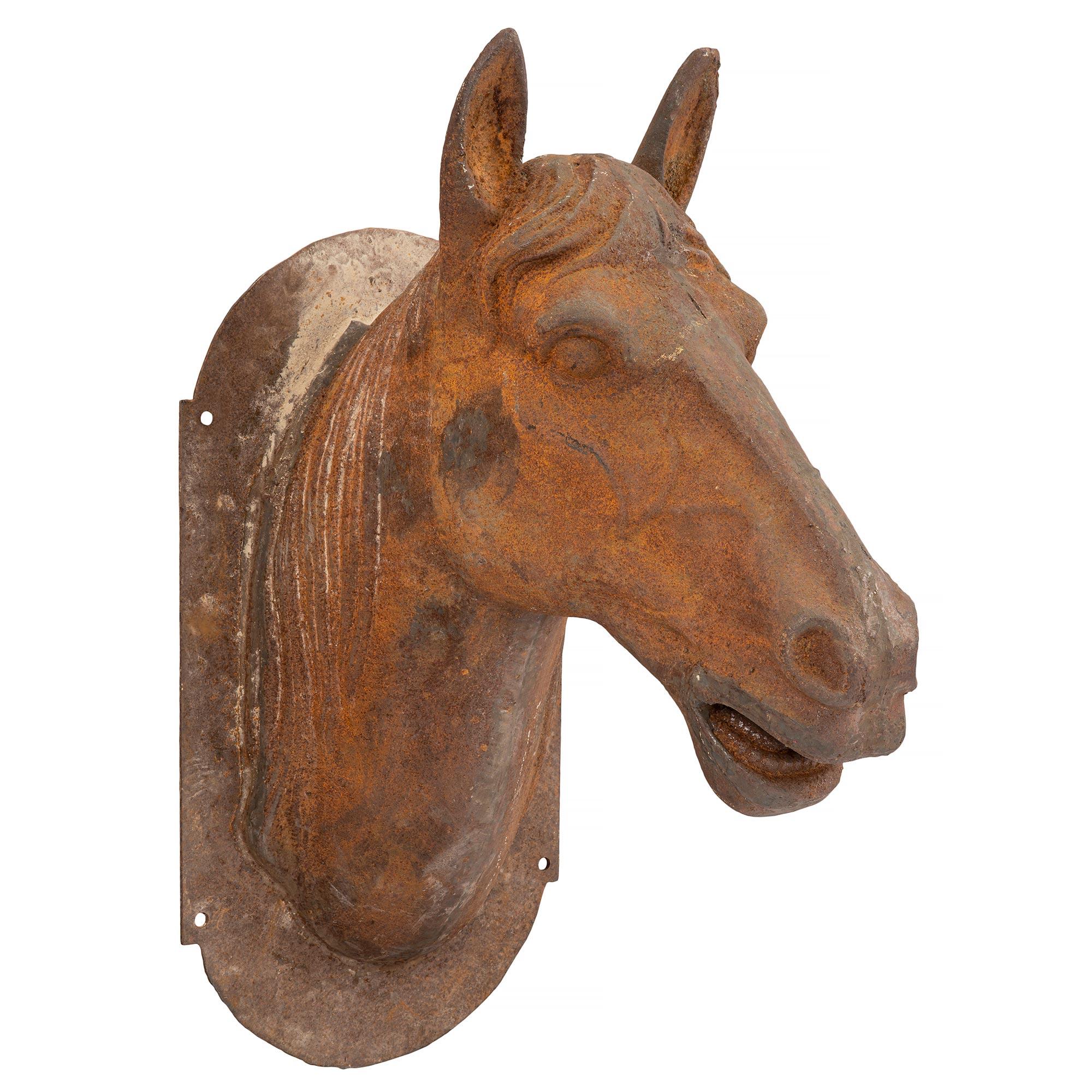 A handsome French late 19th century wall mounted statue of a cast iron horse's head. The statue displays an oblong back plate and lovely intricate detail throughout. All original rich patina.

