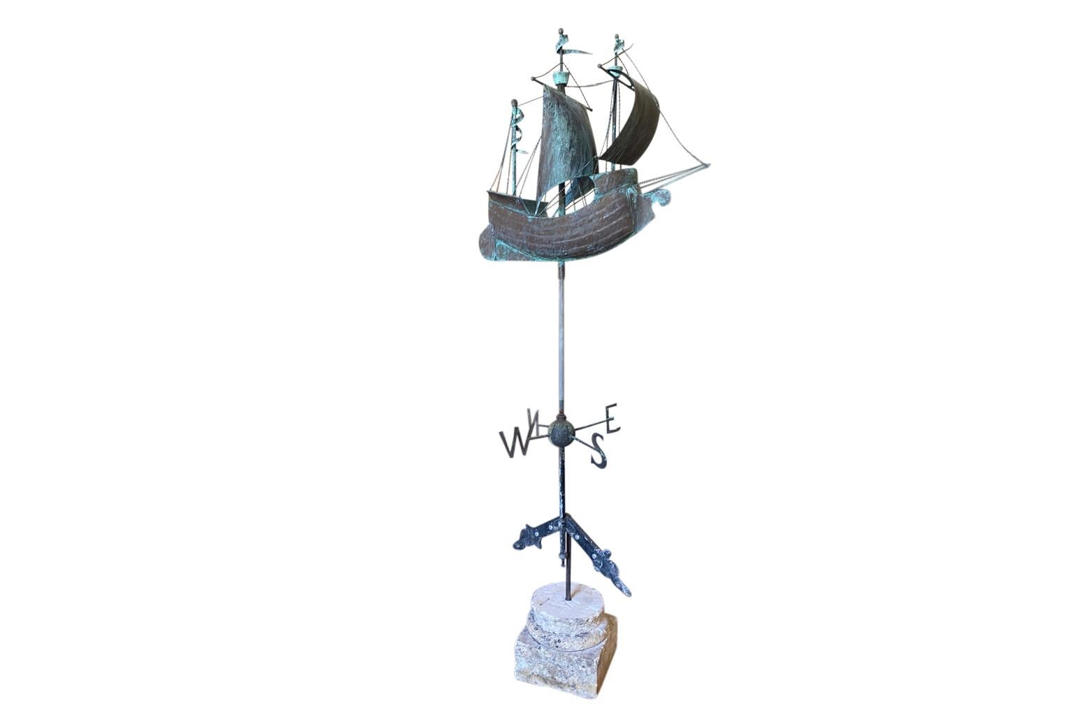 A sensational later 19th century girouette - weathervane of a Galleon found in the South of France. The galleon is expertly crafted from beautifully patina'd copper and rests in its stone base. A wonderful accent piece for any beach or lake house.