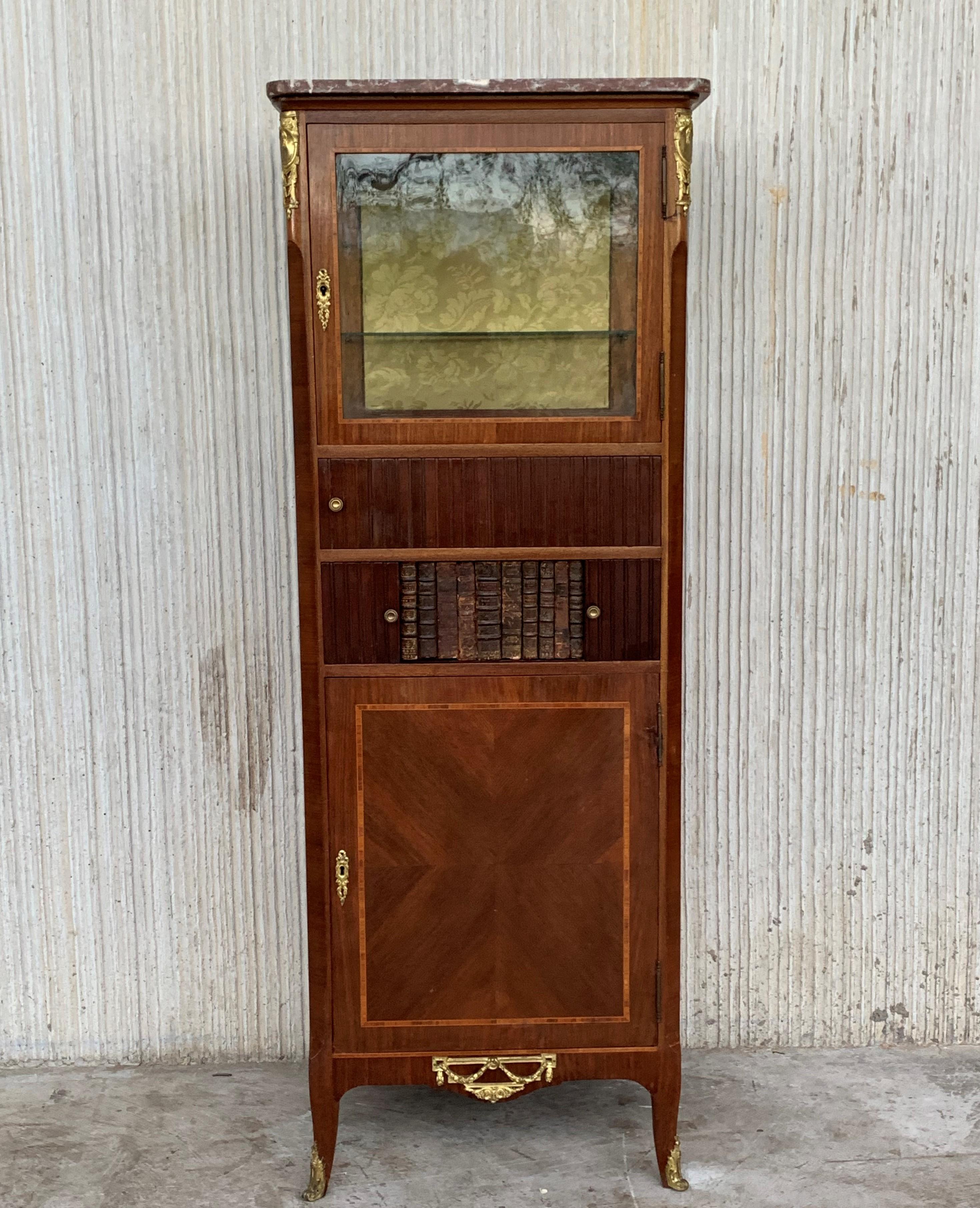 An extremely high quality and elegant French late 19th century Louis XVI period mahogany and ormolu-mounted cabinet vitrine which is finished on all sides. The cabinet is raised by tapered fluted legs with toupie shaped sabots. The legs are joined