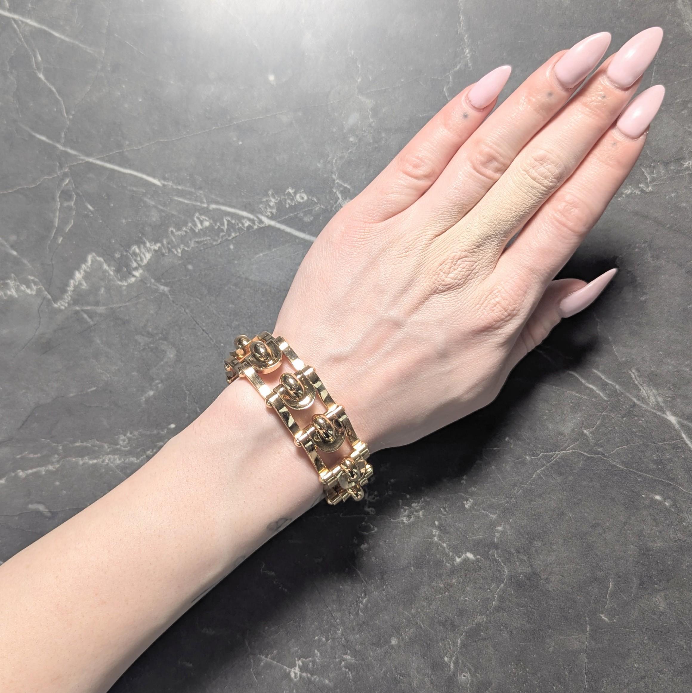 Designed as pierced hinged links featuring dimensional geometric forms
Featuring a minimalist scroll motif profile
Accented by high polish finish
Completed by concealed clasp closure
Tested with French hallmarks for 18 karat gold
Circa: 1935
Width