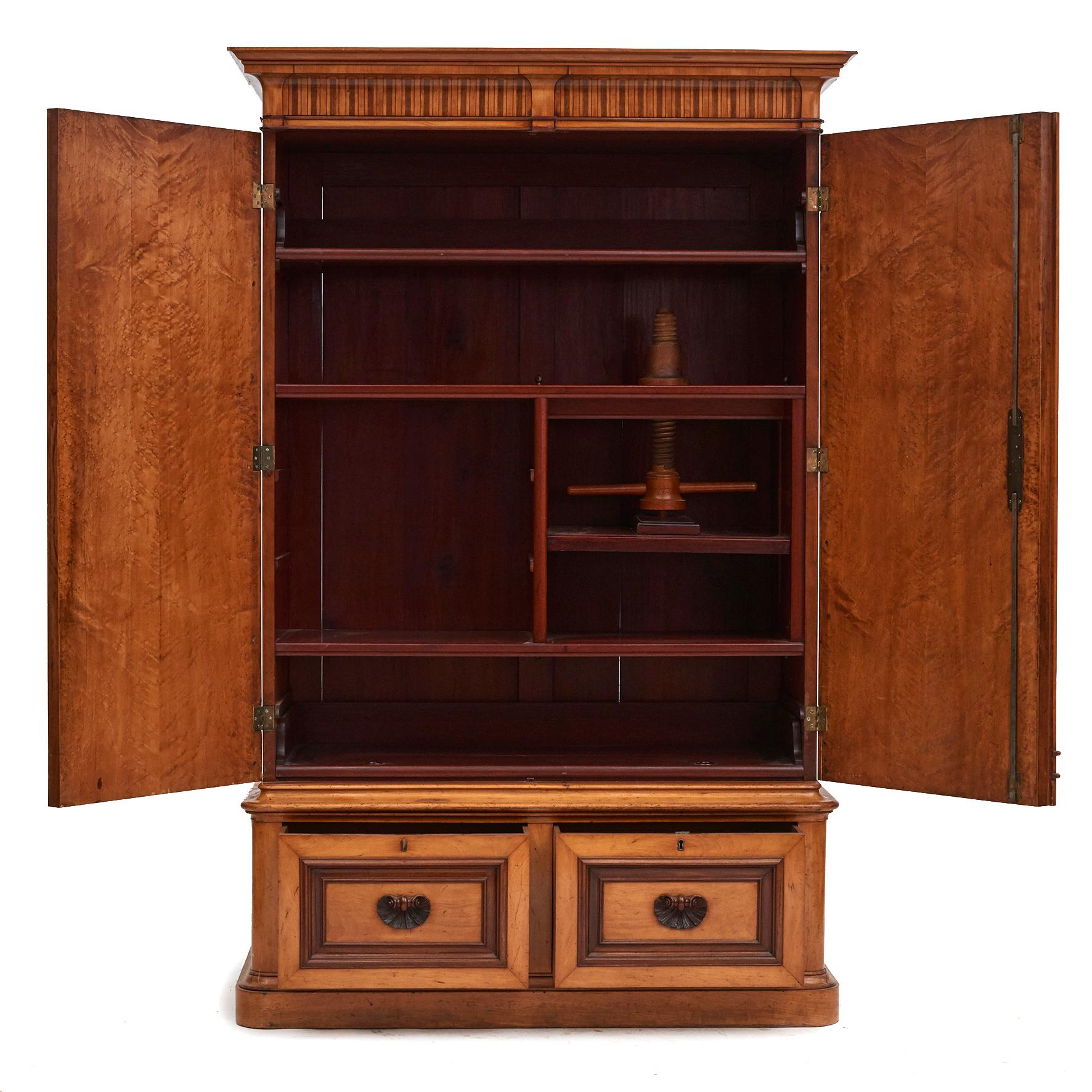 A very good quality French 19th century late Empire linen press cupboard.
Made in maple wood with pair of panelled doors in bird's eye wood and mahogany borders.
At the top a dentil cornice with inlays. Base with two drawers each adorned with