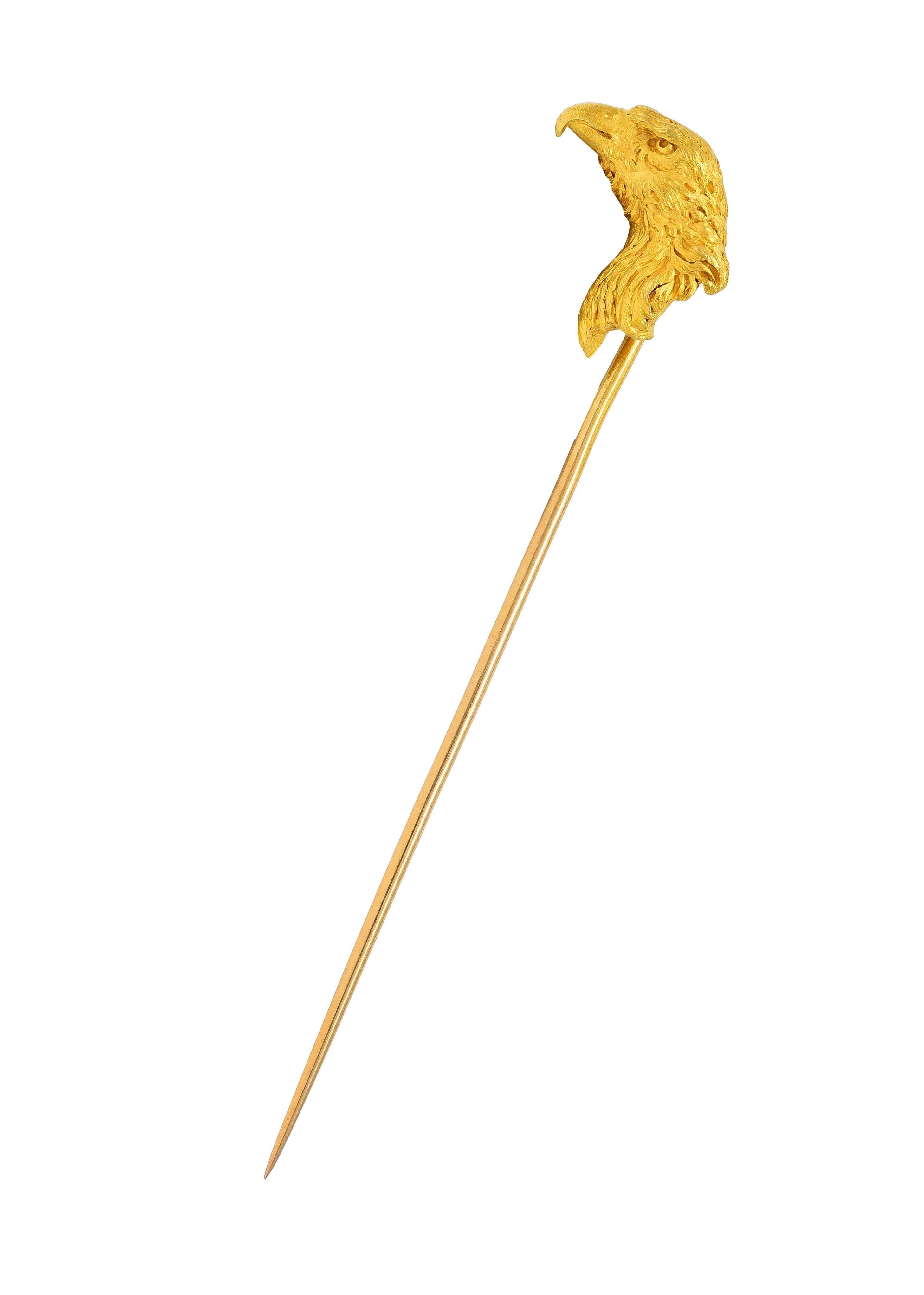 Designed as a highly rendered eagle head in profile
Grooved with swirling feather texture throughout
With furrowed brown and pointe beak
Completed by pinstem
Stamped with French hallmarks for 18 karat gold
With maker's mark
Circa: 1900
Head
