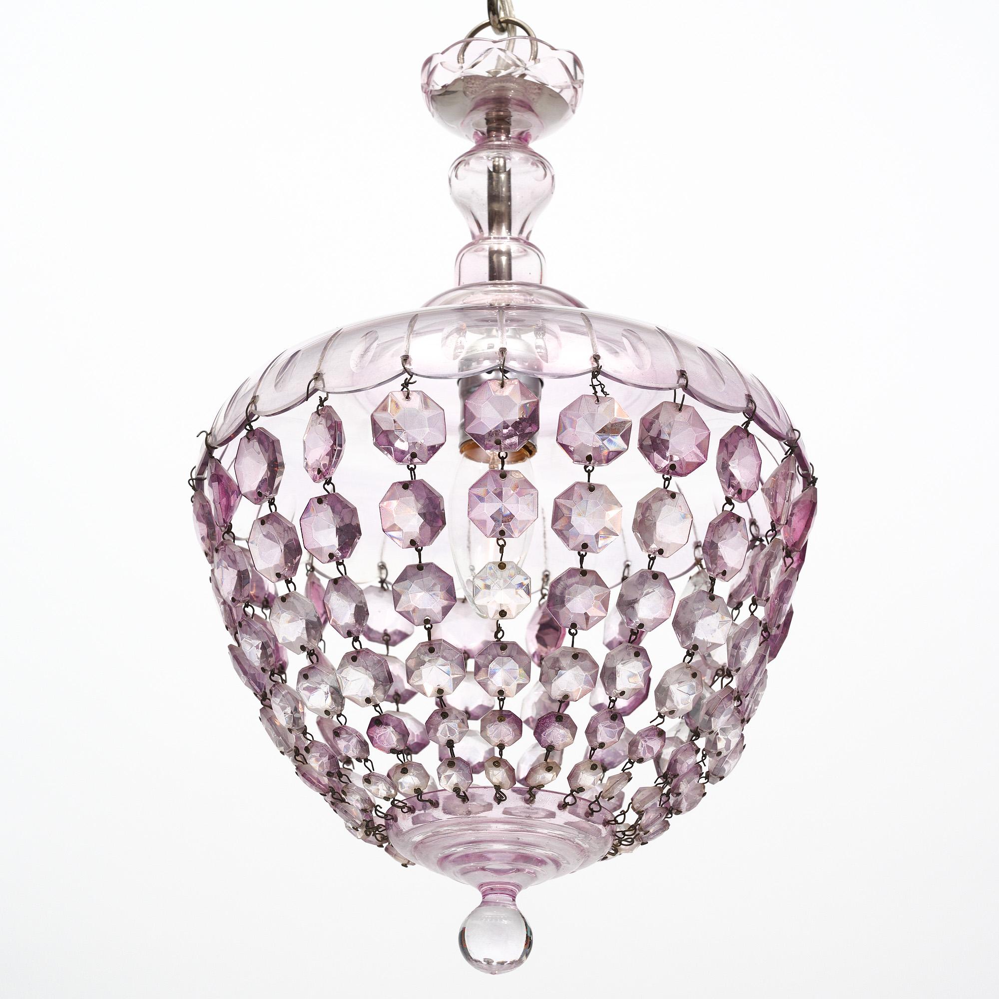 Chandelier from France in the iconic Baccarat bell shape. The crystal top holds strands of cut crystal elements that come together at the crystal finial. This piece is a lovely lavender color. It has been newly wired to fit US standards.
Current