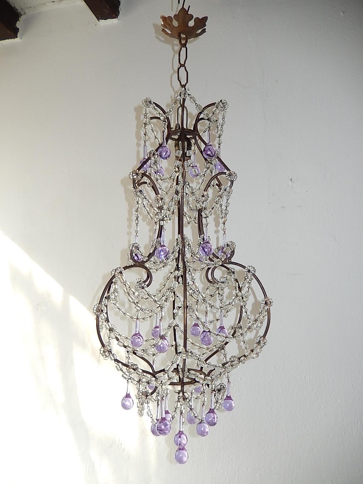 Housing one-light center top. Rewired and ready to hang. Gold gilt metal scroll body with florets throughout. Swags and swags of macaroni beads. Adorning rare Murano vintage lavender drops. Crystal bobeches on bottom. Adding another 8 inches of