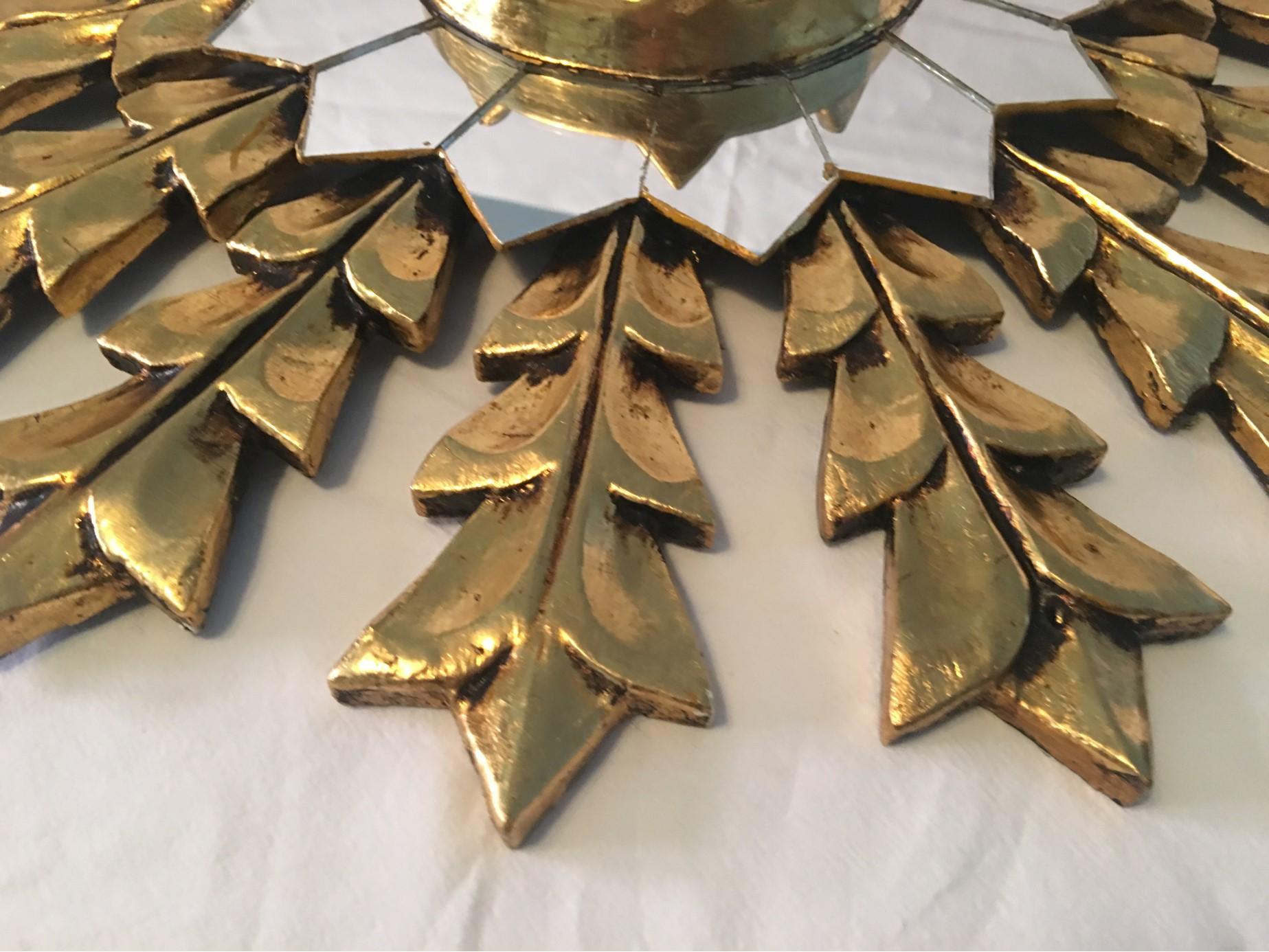 A French midcentury leaf gold on wood starburst wall mirror. Gold leafing applied by hand. Manual hand polish. Very attractive piece.
Measures: 17.5 Inches with a 2 inch depth. Will be lovingly shipped from Europe to Buyer.