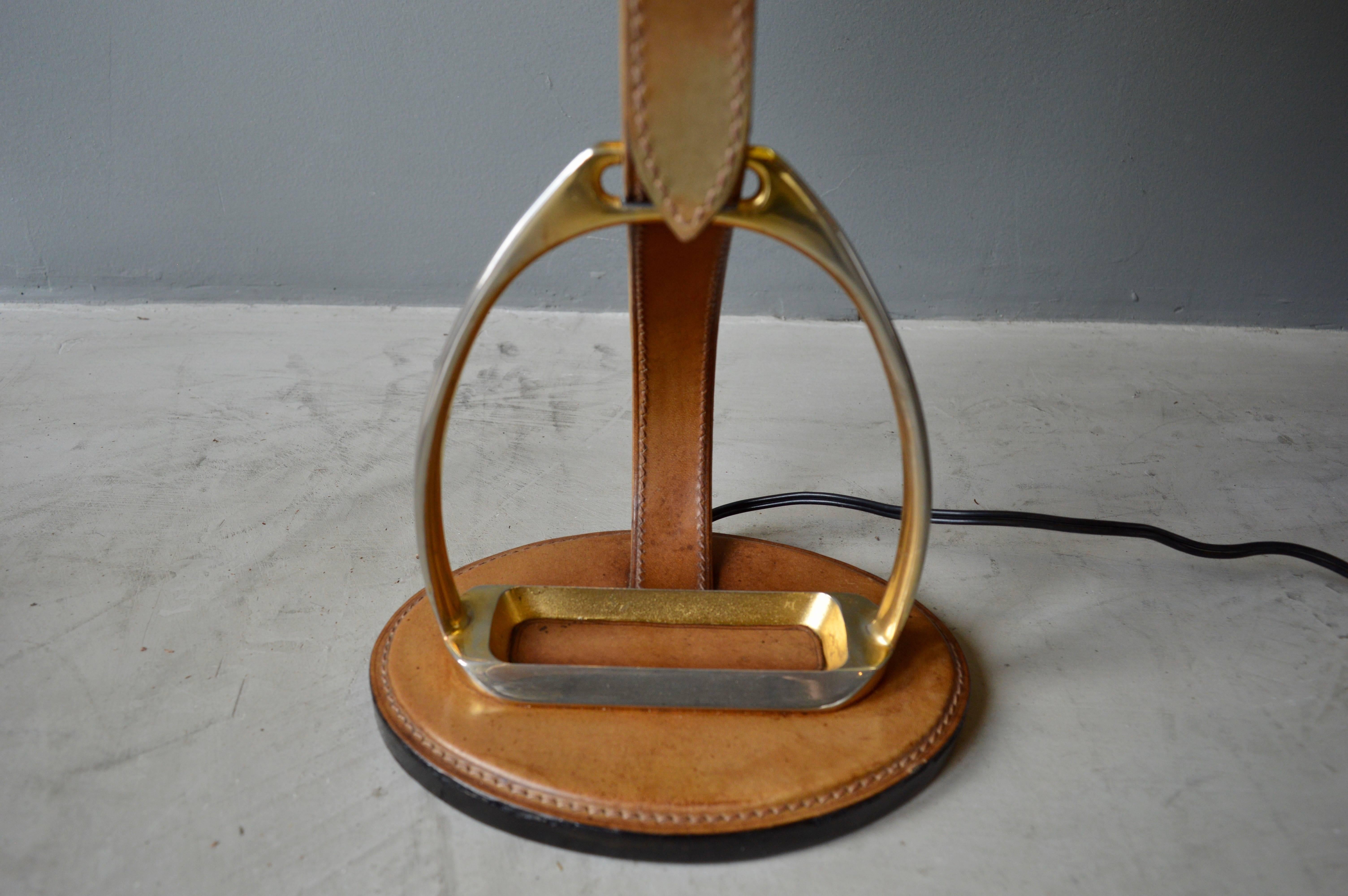 Handsome French and saddle leather table lamp by Longchamps, Paris. Great patina to brass and saddle leather. Newly rewired. Excellent vintage condition. New shade.