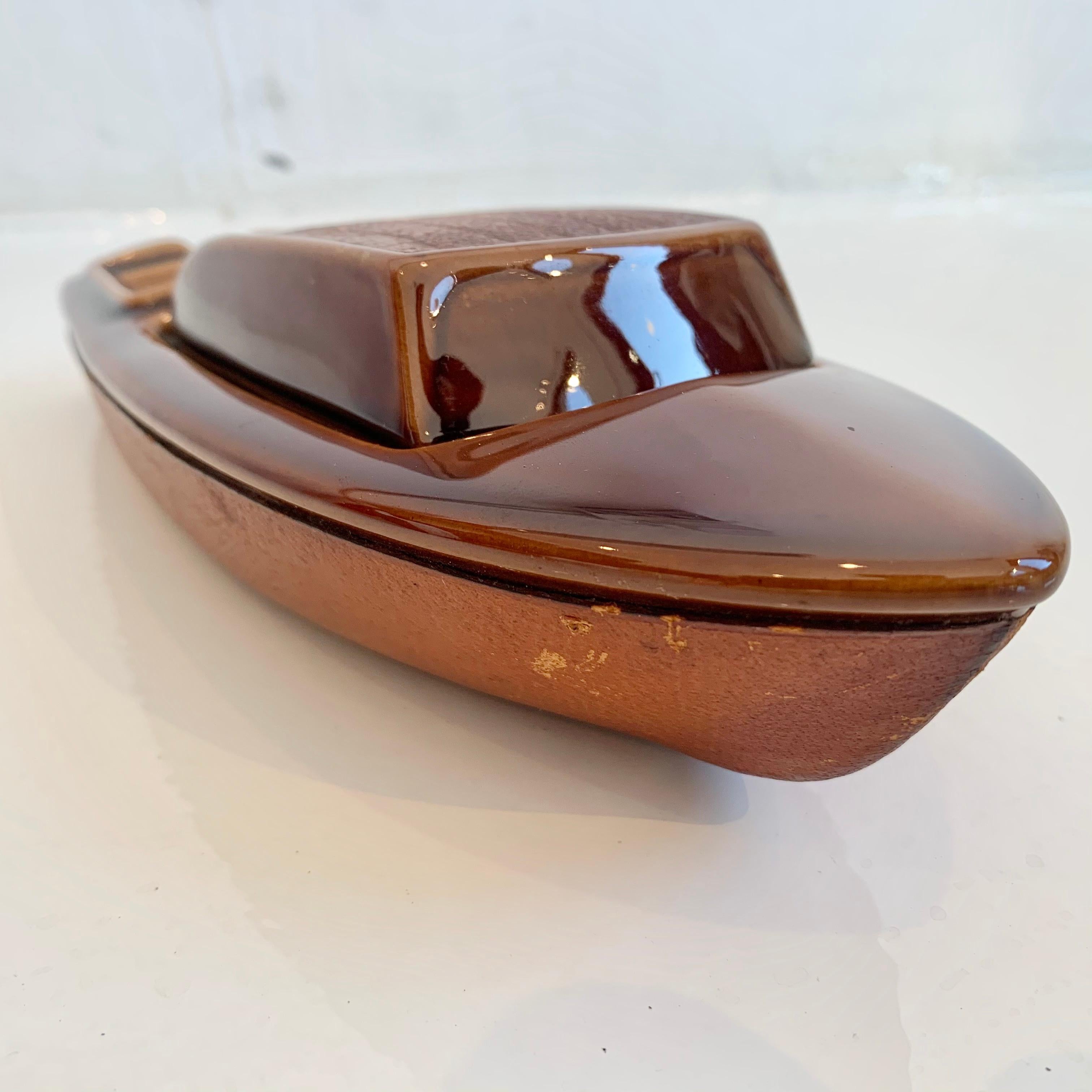 Interesting leather and ceramic boat, made in France. Leather bottom with ceramic interior. Top of boat comes off and reveals a stash box for cigarettes or joints. Ashtray in the back of the boat. Super cool object.