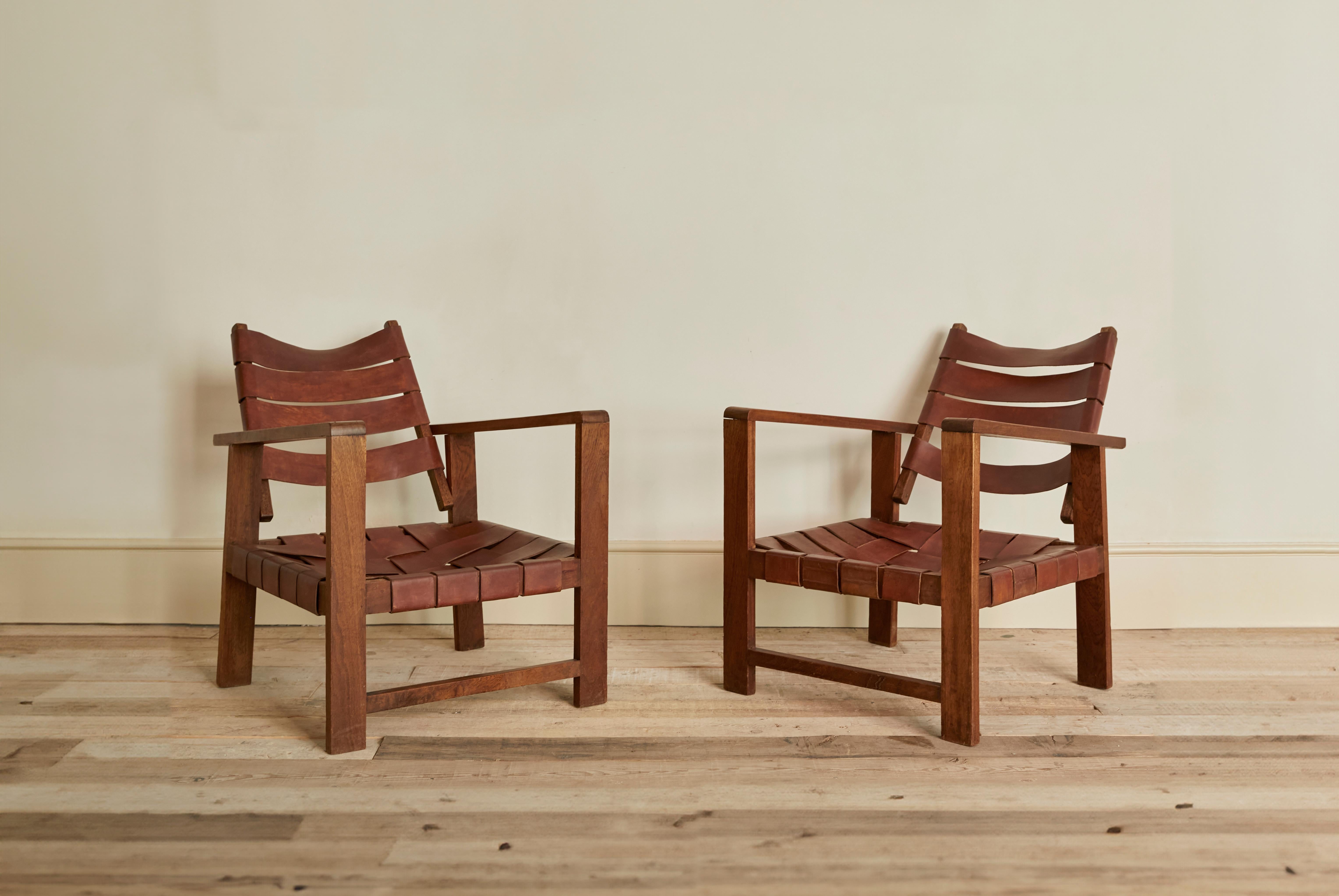 Pair of second hand wooden armchairs with braided leather seats. Leather is combined with the craftsmanship of braiding and the whole structure of the chair is naturalwood material. These chairs come togehter as a pair. They were found in a market