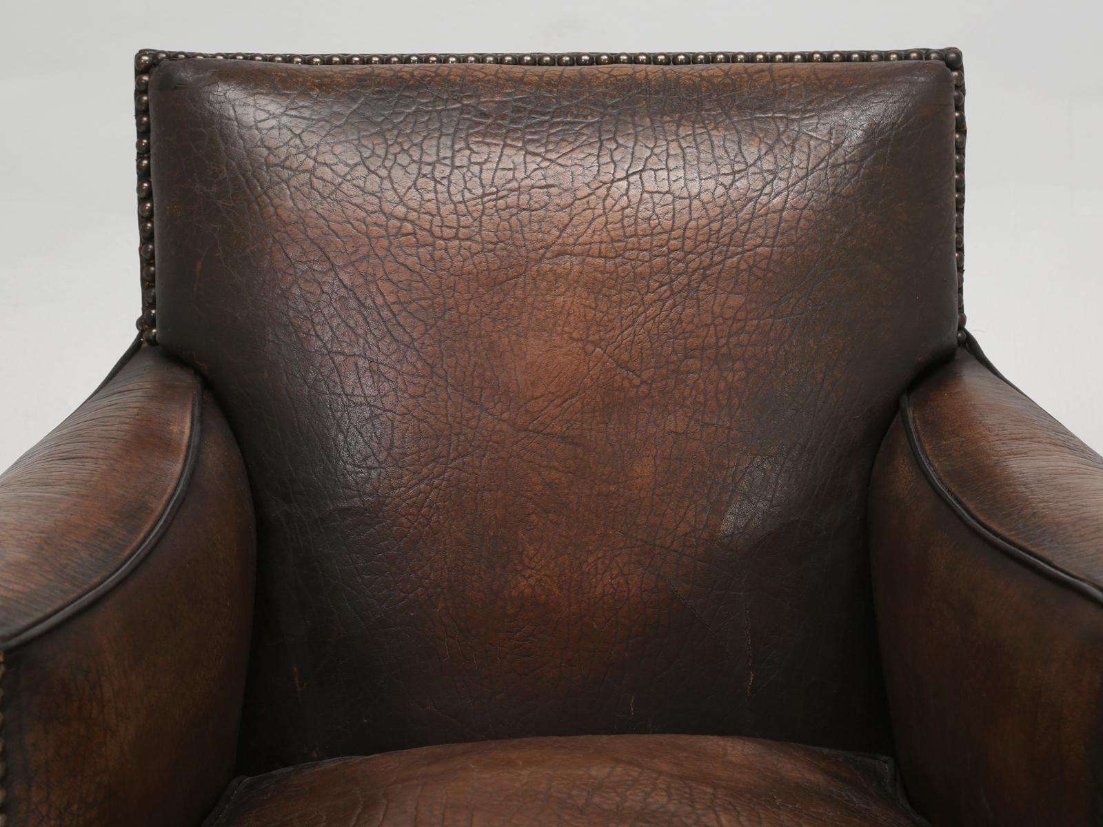 French leather club chair that was made from an unusual eco-friendly elephant pattern embossed cowhide. Our in-house old plank upholstery department, completely disassembled and restored French leather club chair from the inside out. We use
