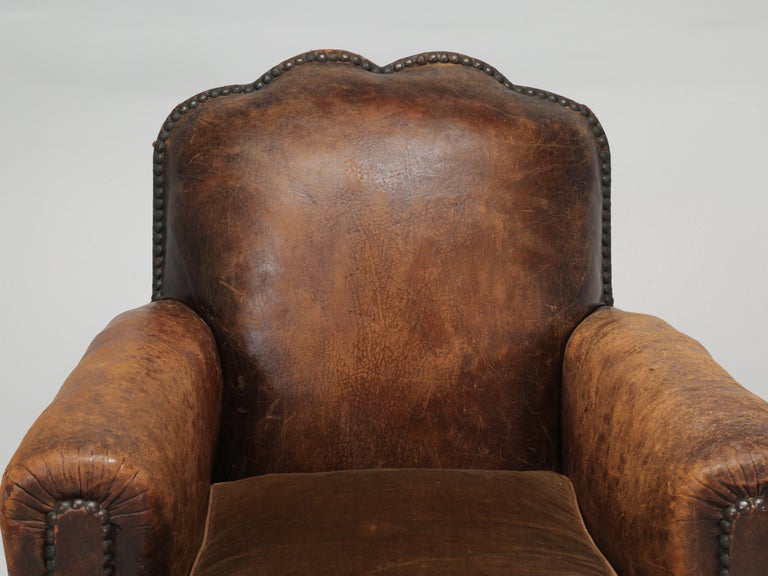 French leather club chair that our Old Plank in house upholstery department has restored internally using only old school materials; such as, horsehair and shredded coco fibers. Restoration for the inside of this French leather club chair required
