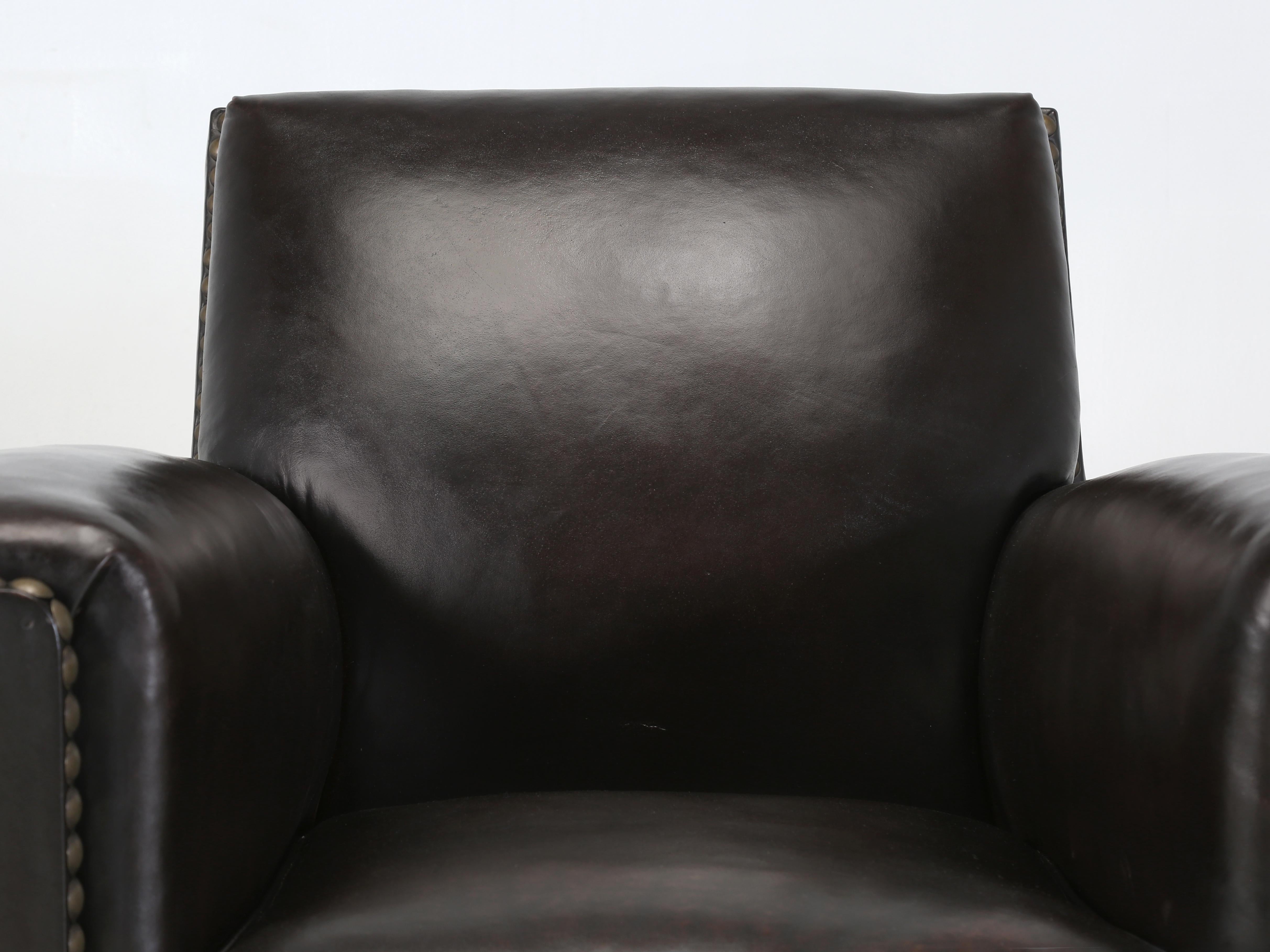 French leather Club Chair (single) that has just gone through a 75-man hour Restoration where nothing was left untouched. Our Old Plank Upholstery Department stripped the original French Leather Club Chair to the bare wood frame and basically built