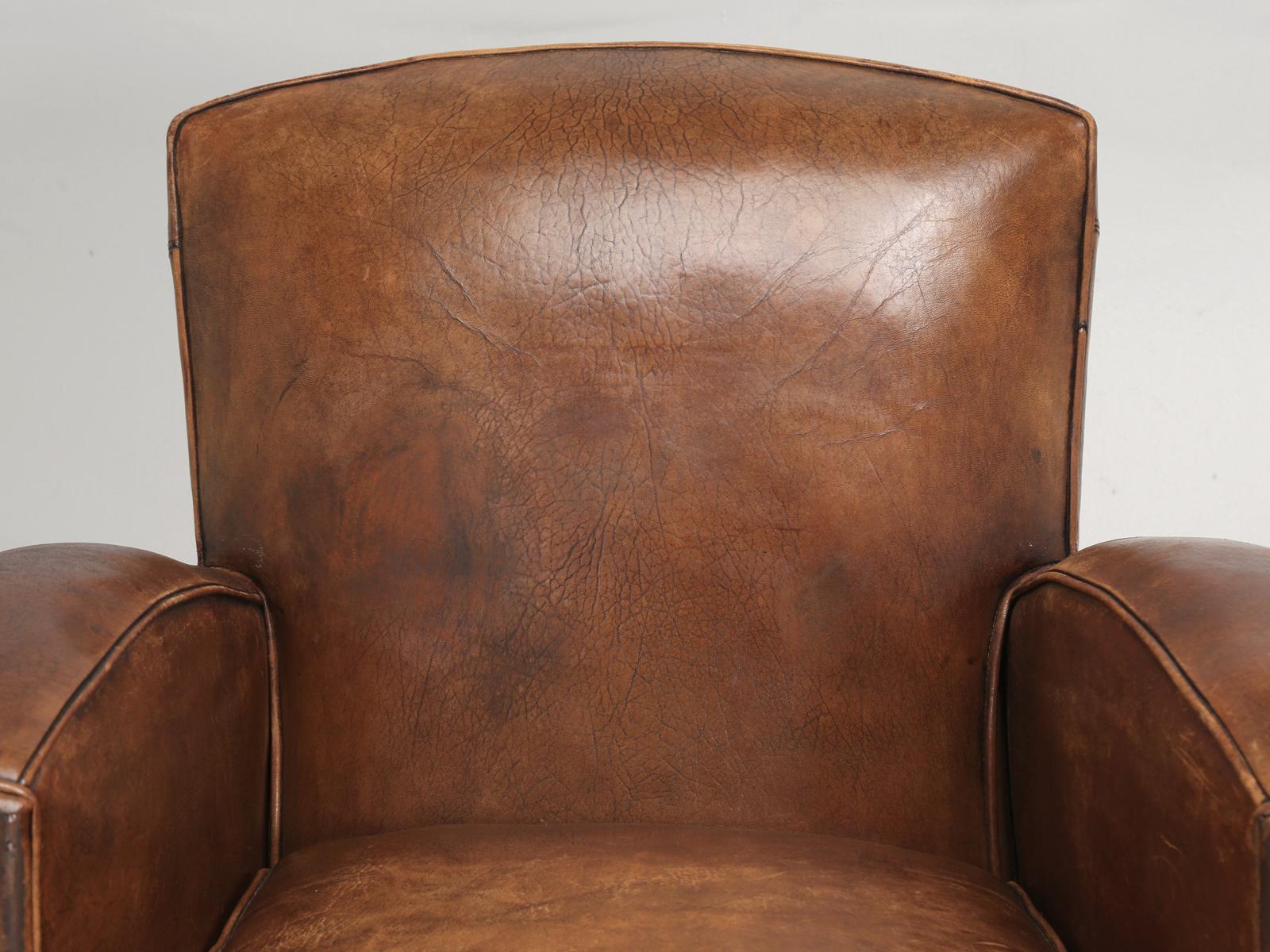 Original French leather club chair. Our in house old plank upholstery department completely and correctly restored the French club chair internally, without disturbing the exterior leather covering. Technically this means, that the French leather