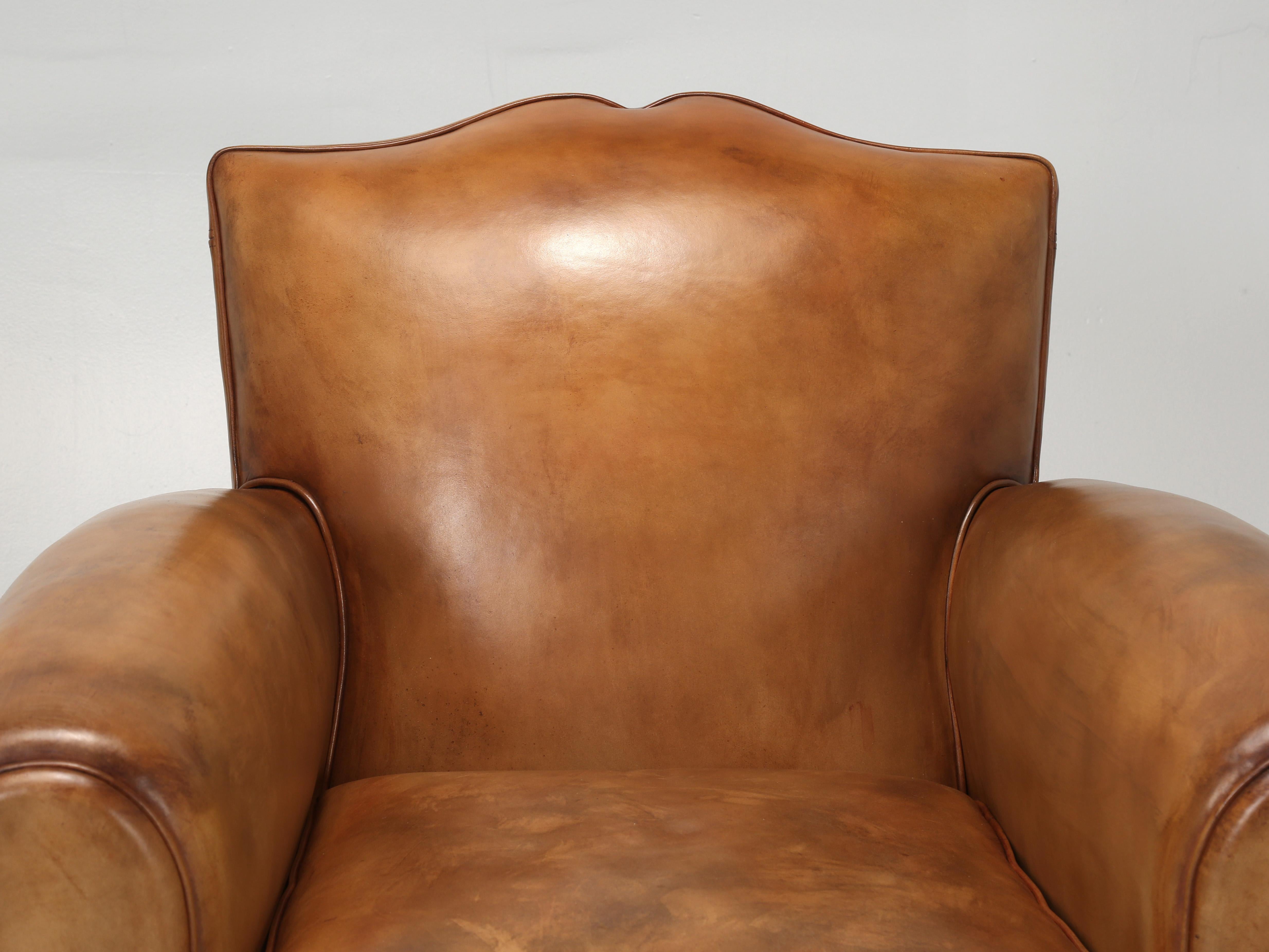 Original pair of French leather club chairs that our inhouse old plank upholstery department has painstakingly totally disassembled and rebuilt using old school methods. The restoration of the French leather club chairs, left nothing untouched,