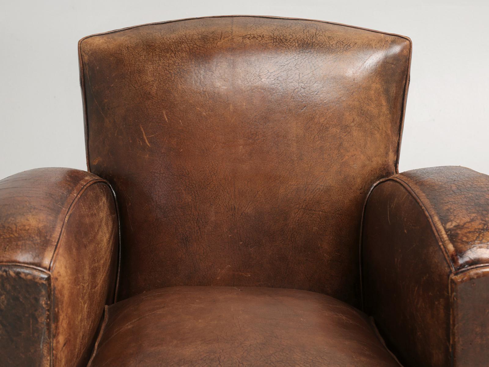 Pair of all original French leather club chairs, that our in-house old plank upholstery department restored internally. What this means technically is, that both of the French leather club chairs were carefully disassembled and the restoration
