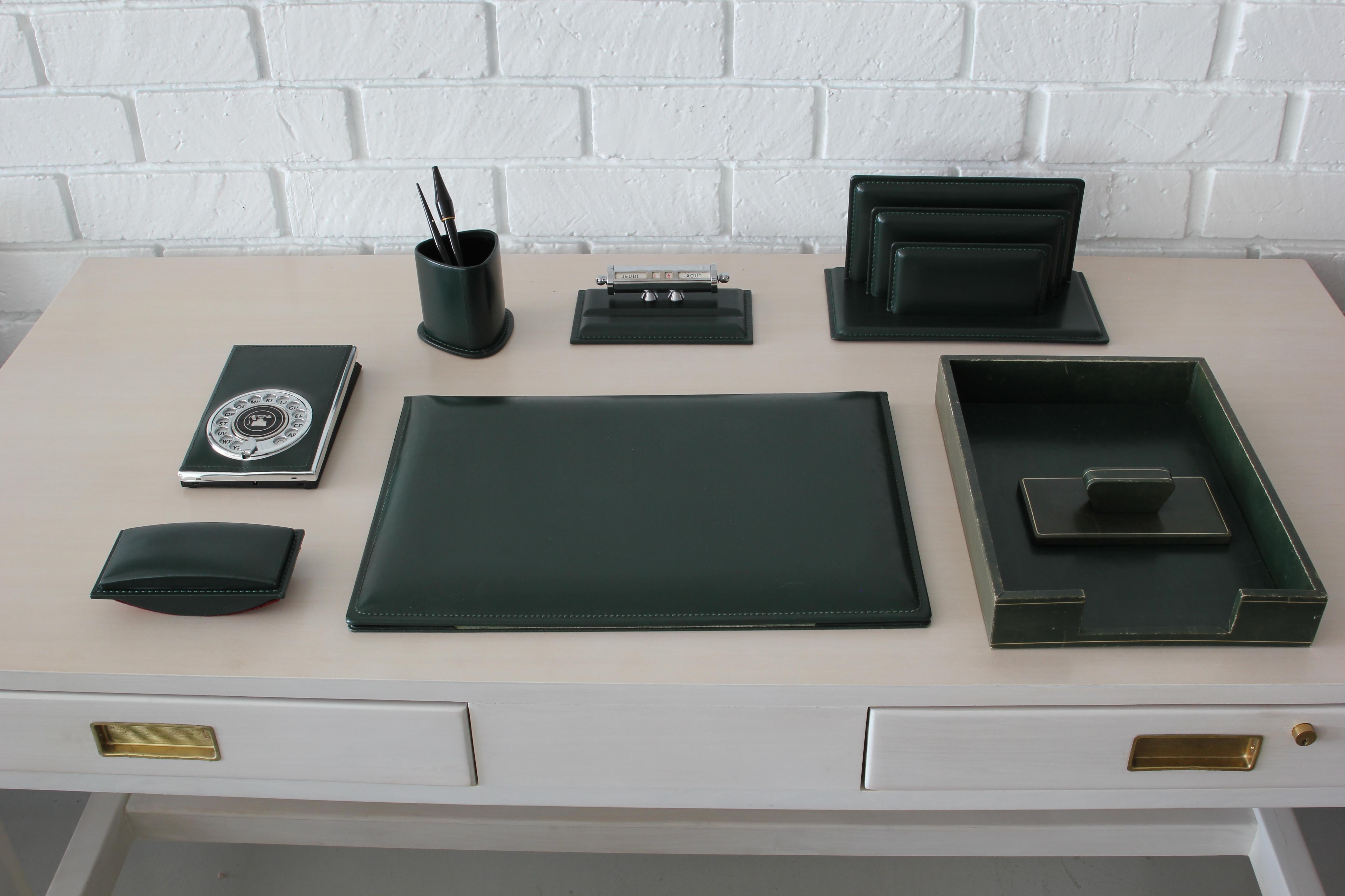 Full French leather desk set in the style of Jacques Adnet.
Dark hunger green leather set includes seven pieces - including paper tray, envelope mail holder, calendar, blotter, pen holder and old fashioned rotary telephone book!
Excellent vintage