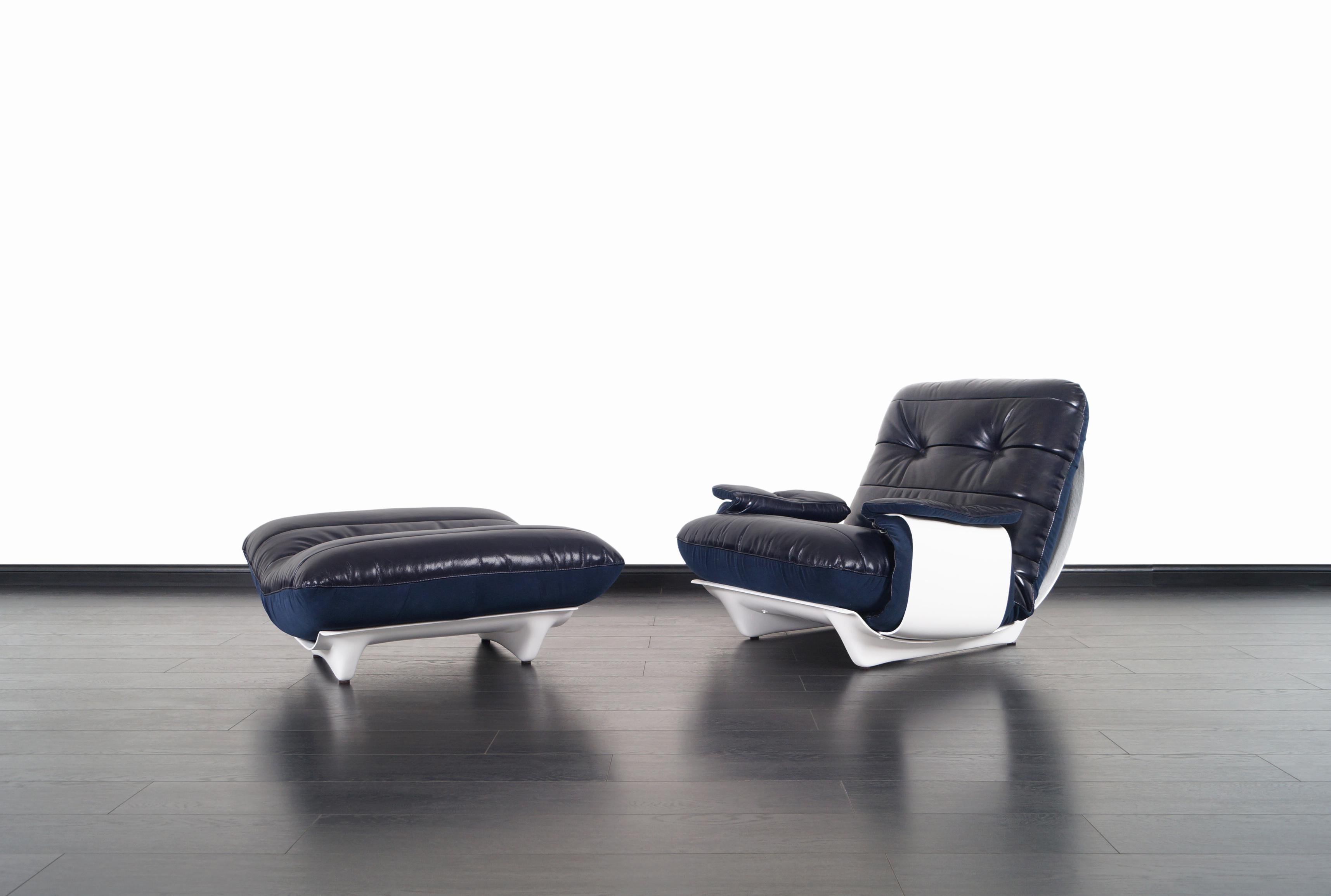 A stunning vintage leather lounge chair and ottoman designed by Michel Ducaroy for Ligne Roset in France. This modernist lounge chair and ottoman are from the 