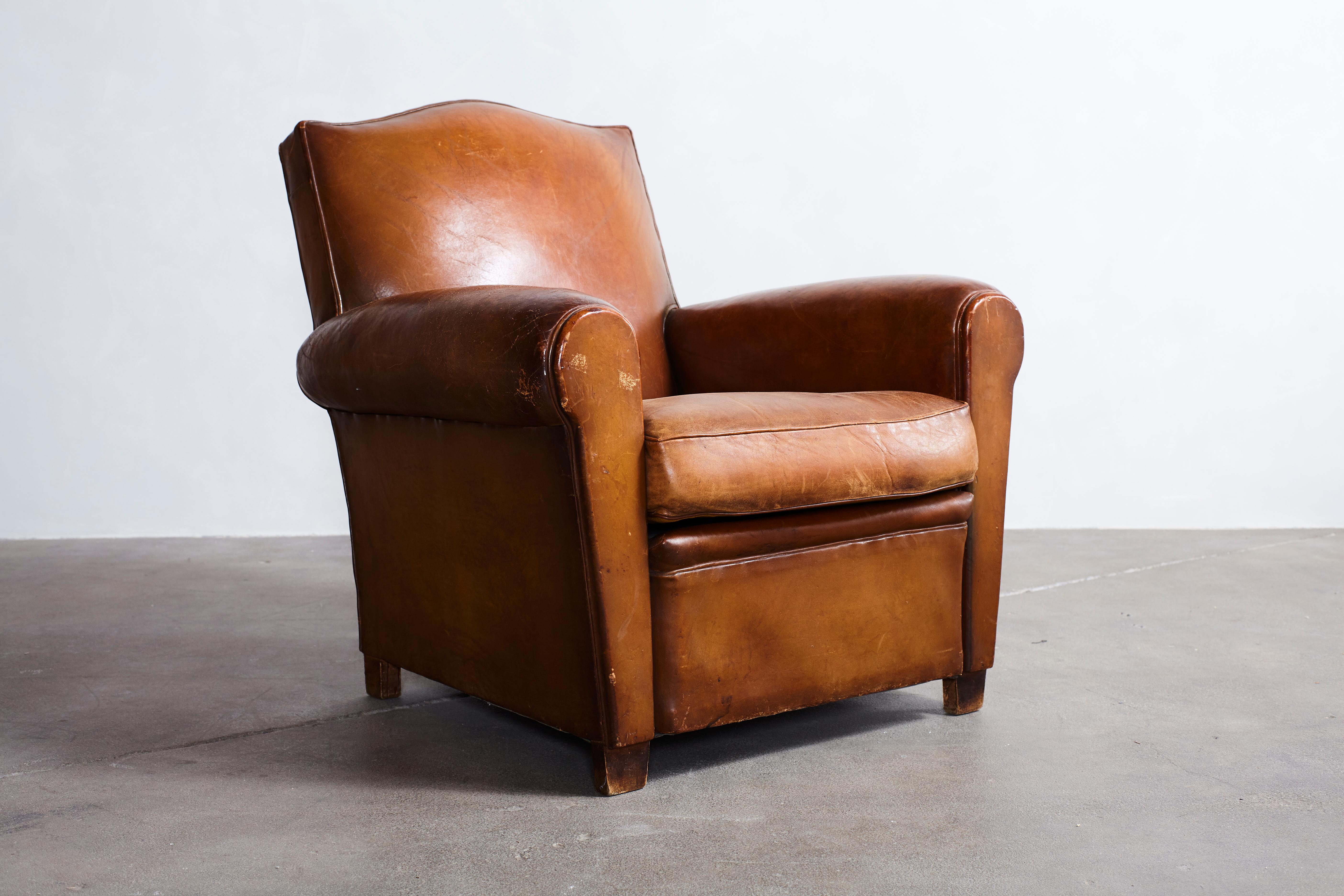 French leather petite club chair with unique crown top details.