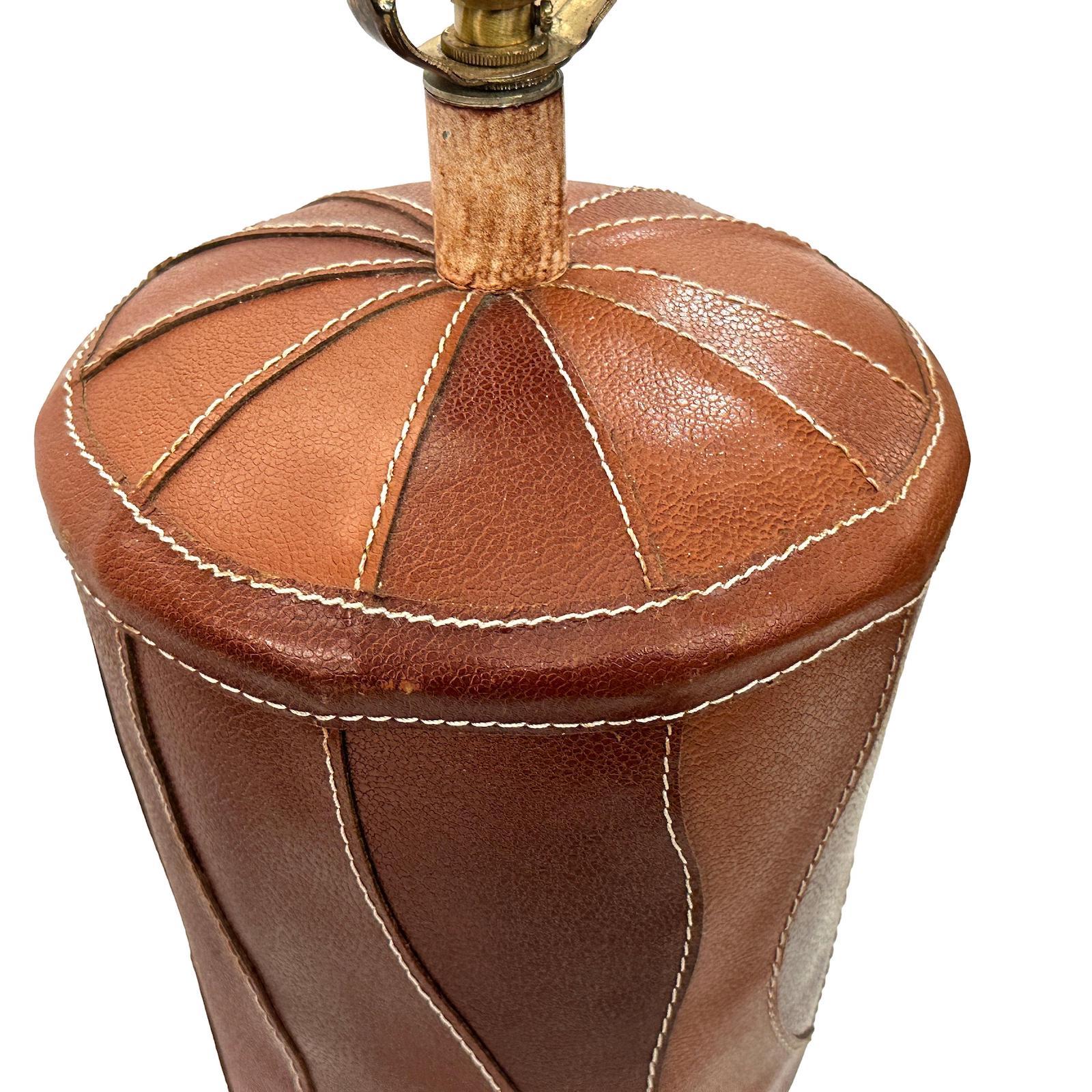 A single circa 1970's French leather covered table lamp.

Measurements:
Height of body: 20