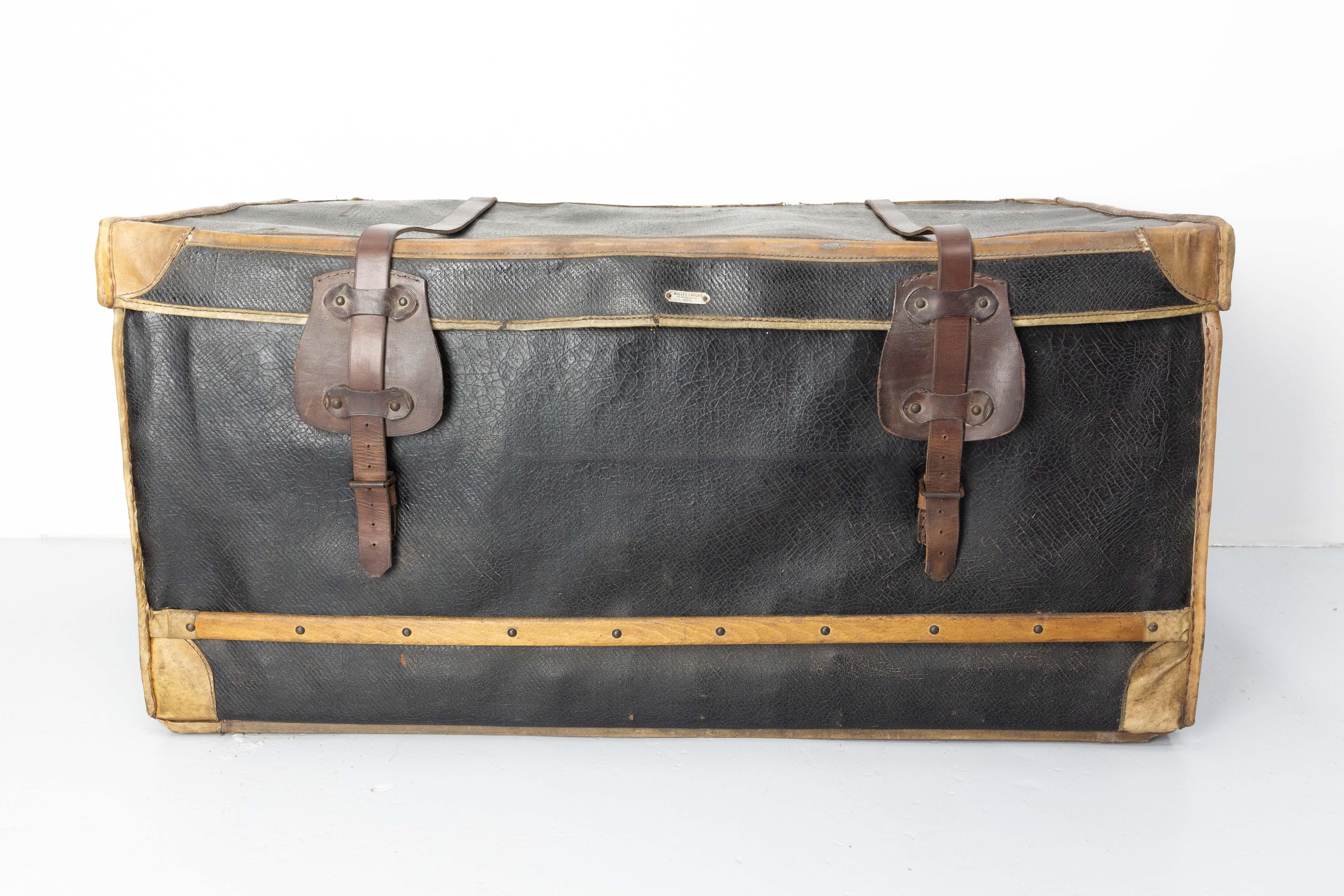 French antique trunk, made of wicker, coated canvas, and with leather belts. Two train labels from a journey from Paris to Chantilly (city known for her castel and her royal stables).
Made by Maison Lavoet, 175 Boulevard Haussmann, Paris., with the