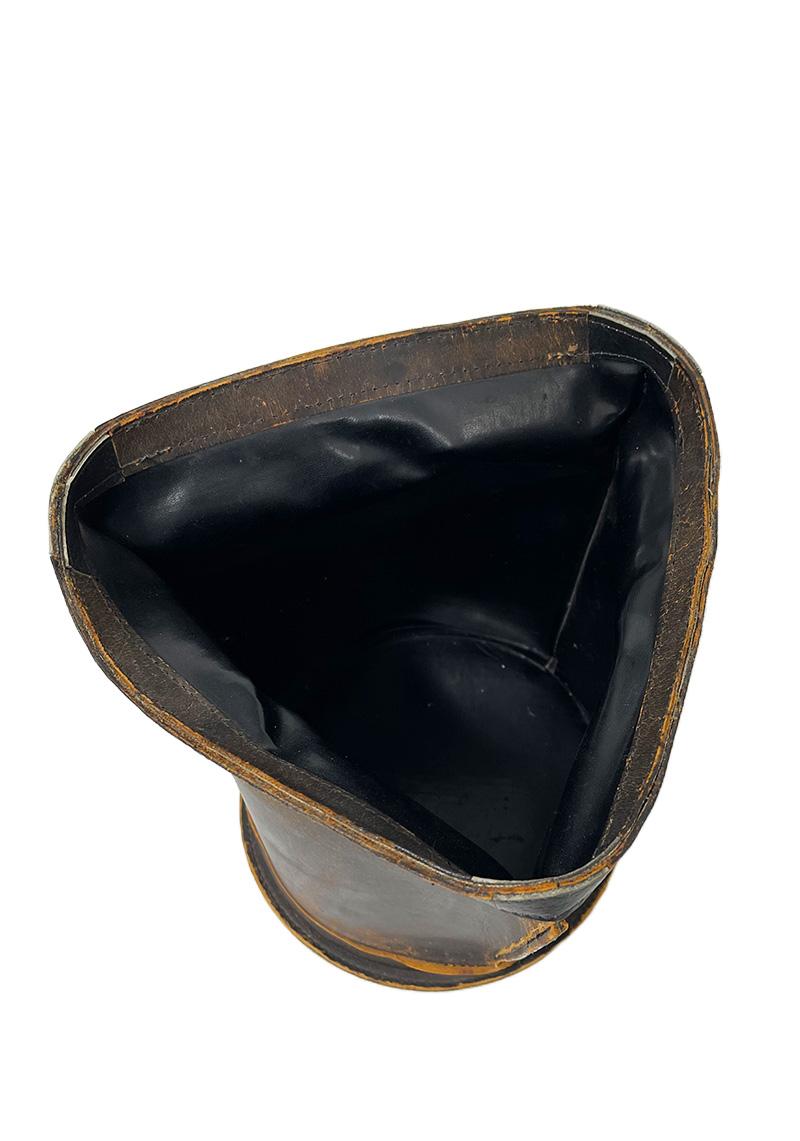 French Leather waste basket, 1960s

A French leather waste basket in a triangle shape on a round base. Beautiful brown patinated leather. The measurement is 27 cm high and the bottom is 22.3 cm diagonal. 
The weight is 574 grams.