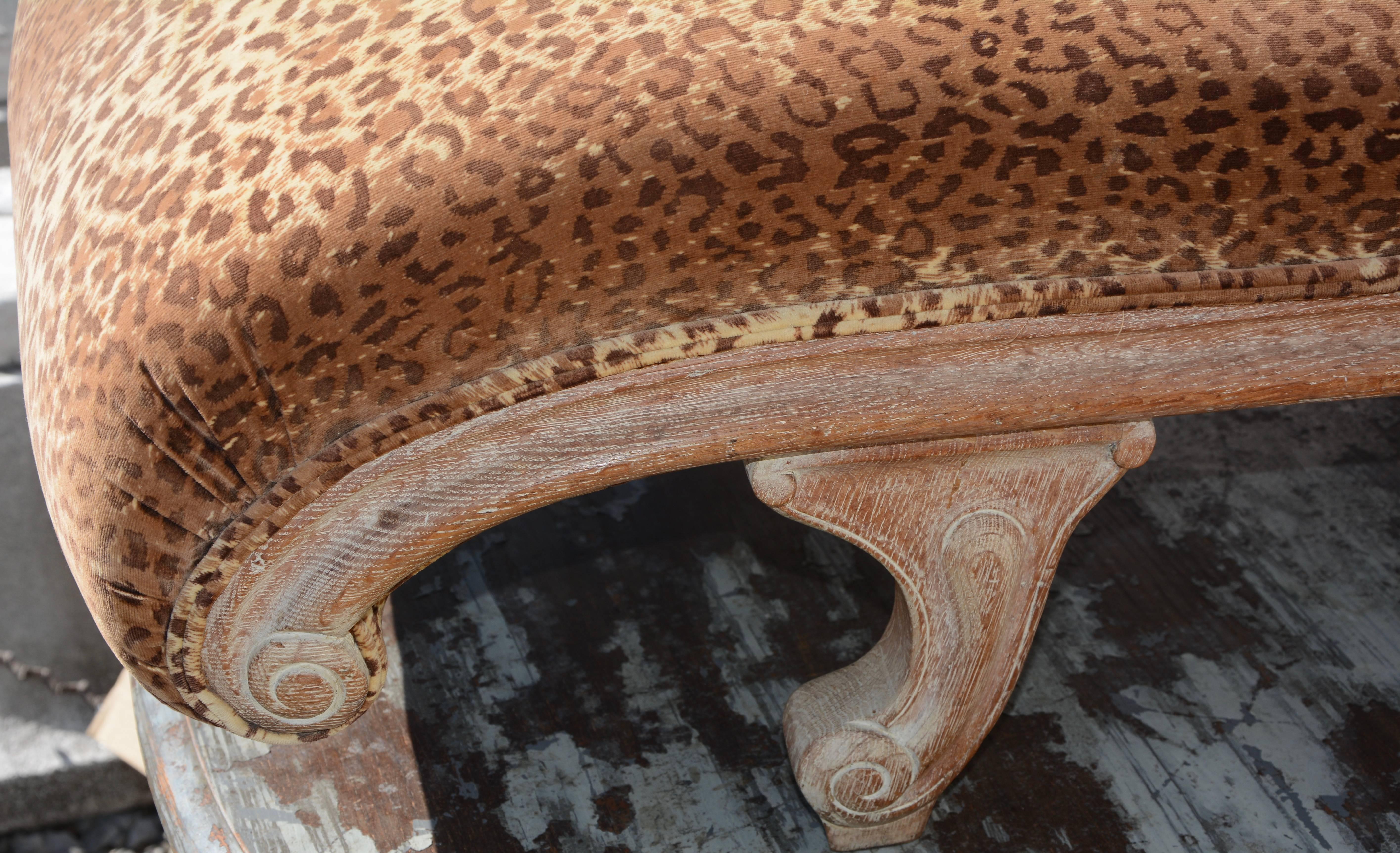 Offering this gorgeous French Leopard print velvet chaises lounge. The curved wood framing of the chaise has been bleached and distressed to add to the character of this piece. The tufted back and side rest have fabric covered buttons and there is