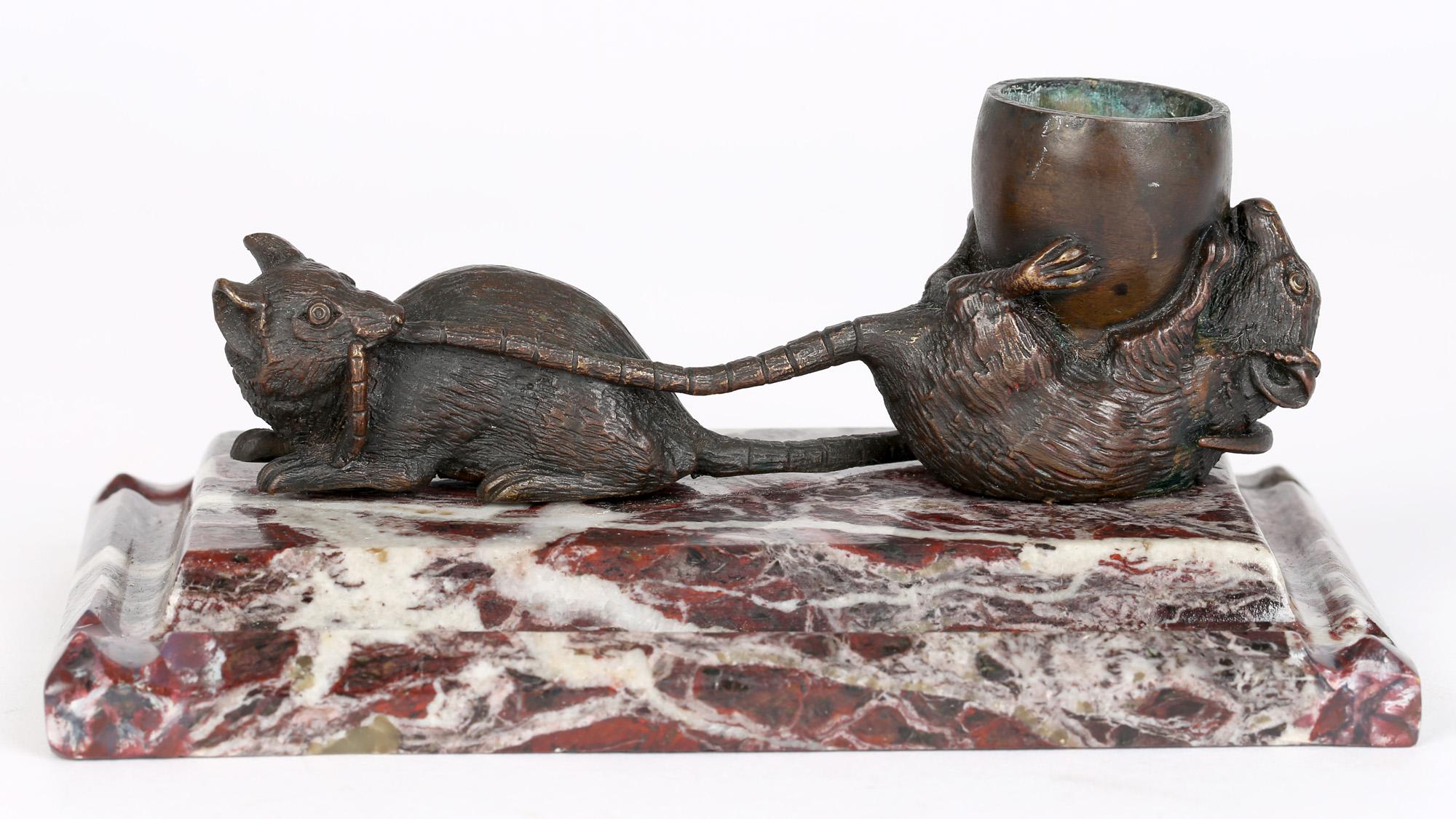 An antique French novelty bronze inkwell modeled as 'Les deux rats et l'oeuf' mounted on a red veined marble base and dating from the latter 19th century. The inkwell is based on the French fable by Jean de La Fontaine 'The Two Rats and the Egg' and