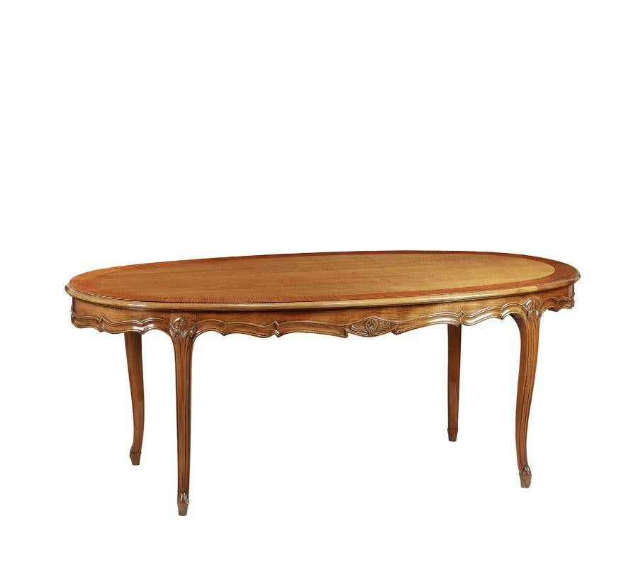 A perfect reproduction of an original French Liberty design from the 1880-1915 period, this stupendous dining table is handcrafted of cherry wood enriched with a magnificent and elegant bois de rose rim. It is a precious, one-off design that will