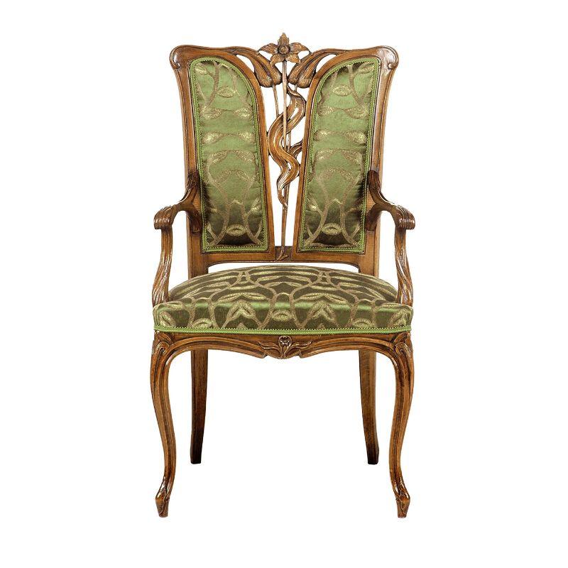 An elegant and shimmering green upholstery decorated with leaf motifs is the distinctive feature of this French Liberty-style armchair, a flawless reproduction of an original piece created in 1880-1915. Handcrafted by expert artisans, its wooden