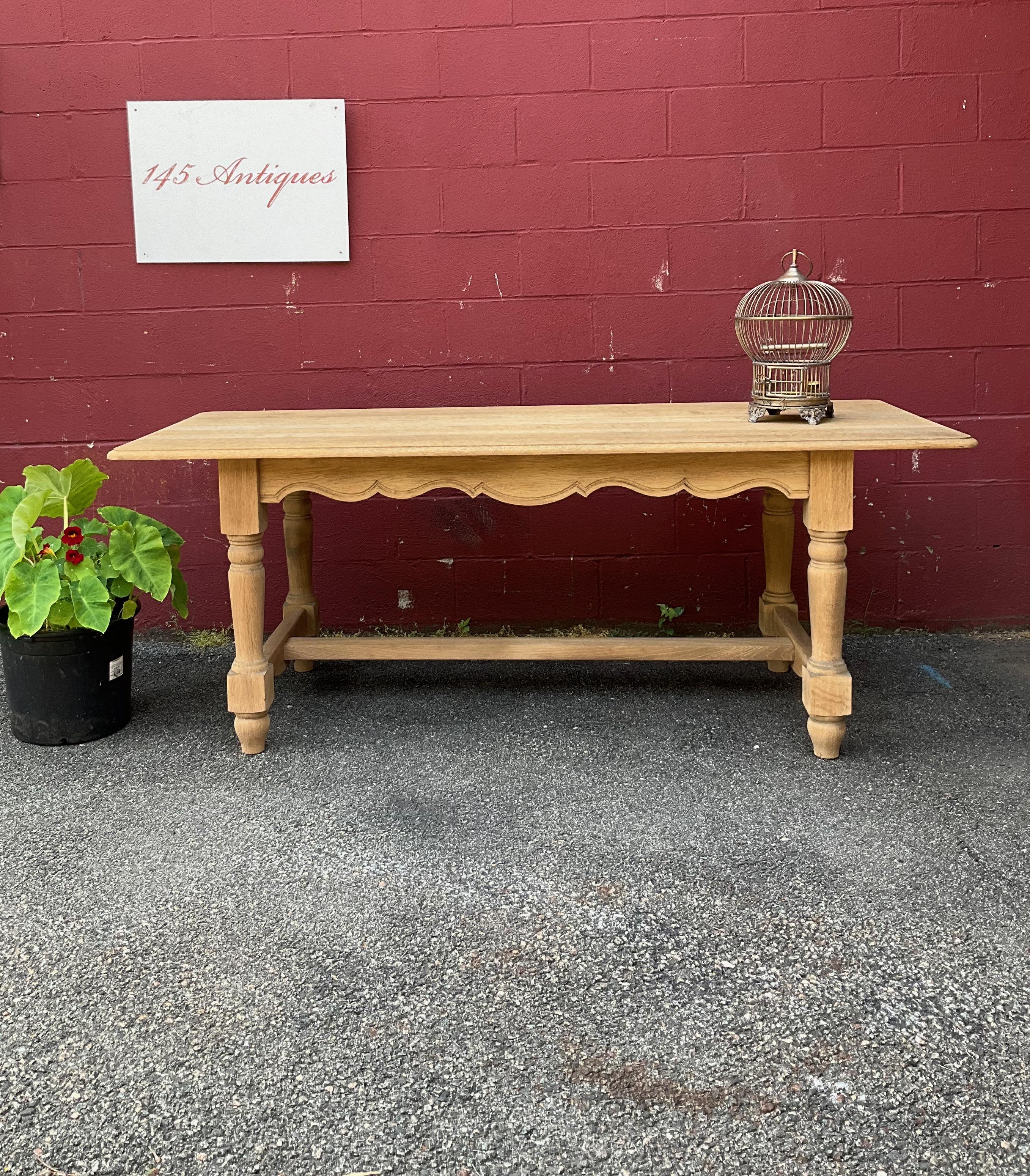 This vintage French library table in bleached oak is a rare find that will elevate any room it's placed in. The large 1950s French library or hall table boasts an impressive size of 30 inches in height, 85½ inches in width, and 35¼ inches in depth,