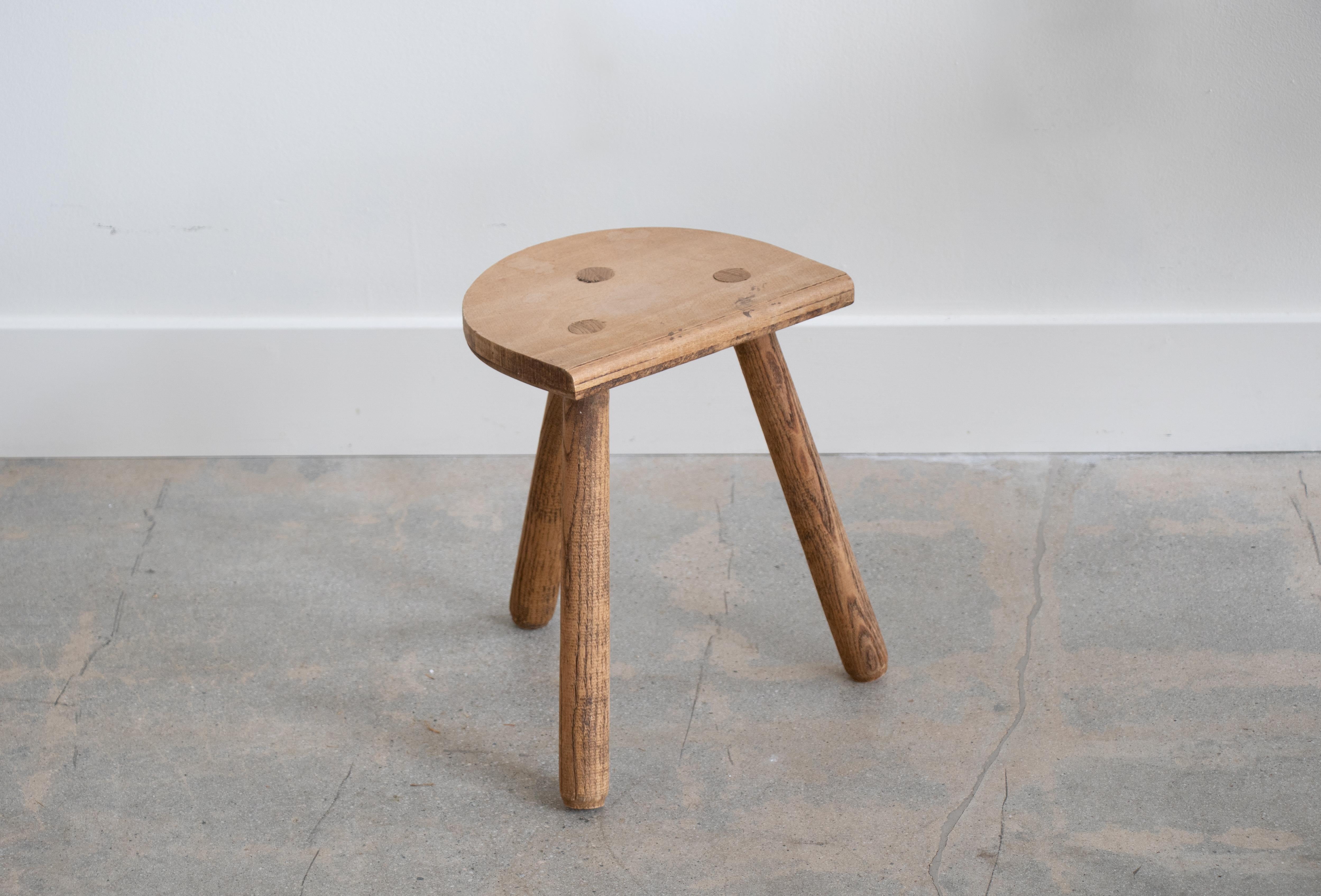 Vintage light oak stool with beautiful tripod legs from France. Original wood finish with great age markings and patina. Can be used as a small stool or as side table next to chairs. 

 