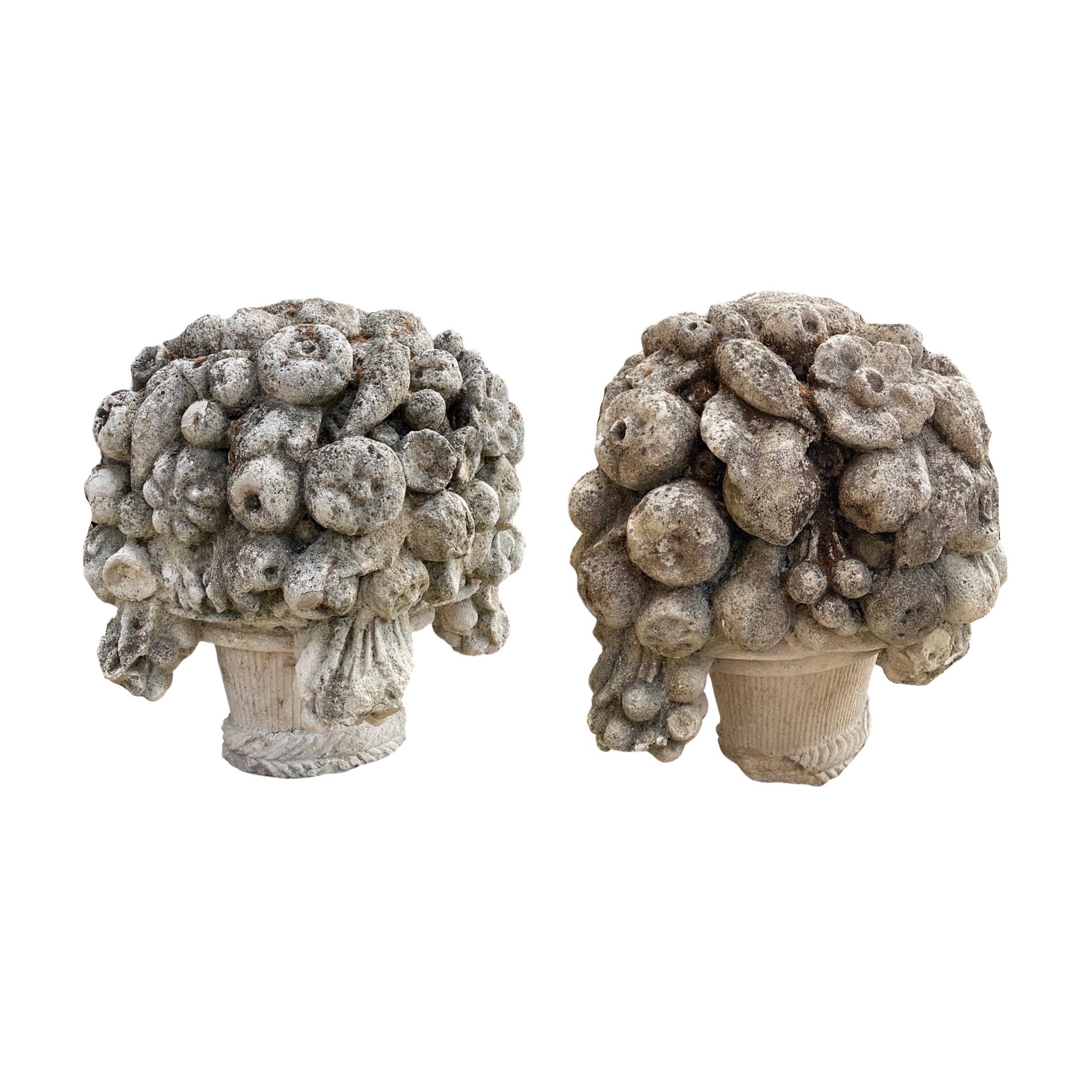 This unique pair of exquisite French limestone sculptures dates back to the 1850s. Carefully crafted from limestone, each sculpture features a beautiful bouquet of carved flowers. Imported from France, these sculptures are sure to complement your