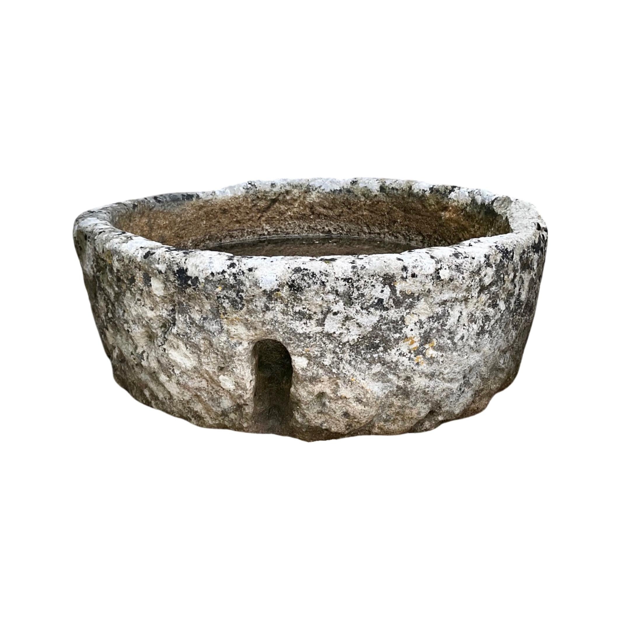 The French Limestone Circular Trough from the 18th century adds a touch of elegance to any garden. Crafted from premium limestone, it features 2 drainage holes for efficient water drainage. Perfect for any outdoor space and adds a touch of