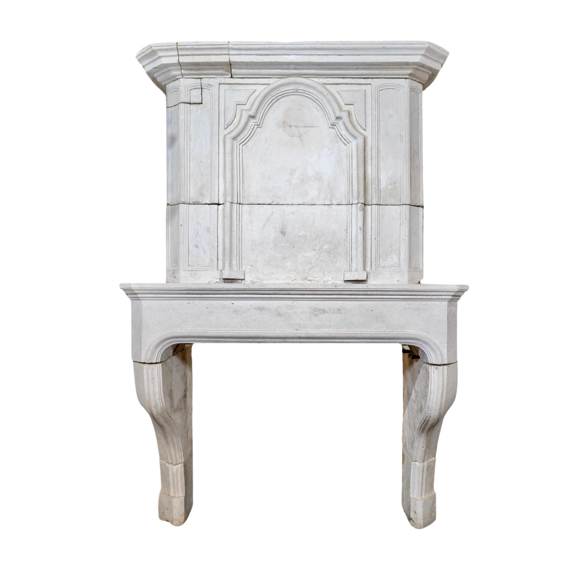 Crafted from the finest French limestone, this Louis XIV style mantel fireplace adds a touch of elegance to any space. Originating from France circa 1710, it exudes timeless beauty and sophistication. Elevate your home with this exquisite piece,