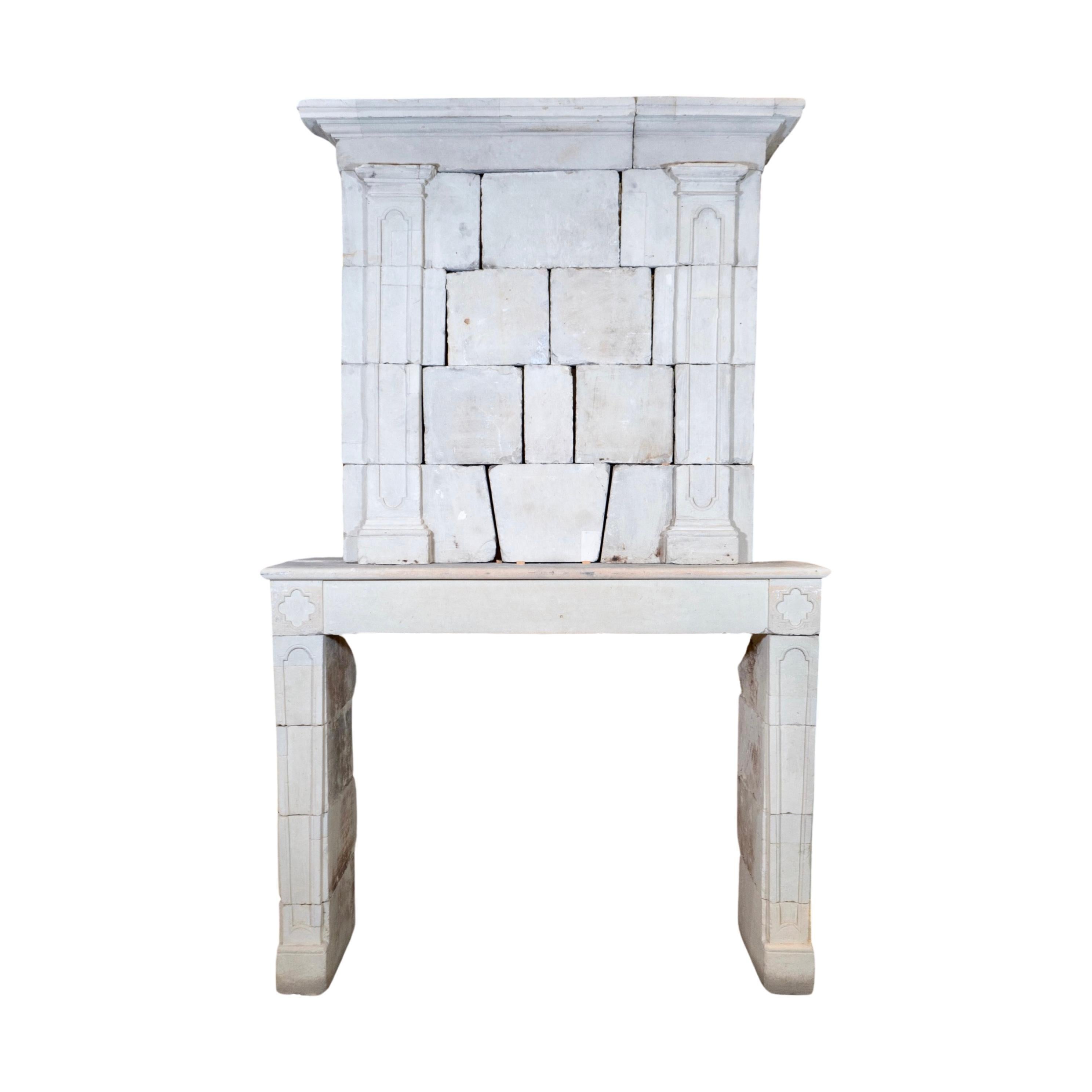 This antique French Limestone Mantel is a masterpiece from the 1720s, featuring intricate carvings and a trumeau. Handcrafted from authentic limestone, this fireplace mantel adds elegance and sophistication to any room. From France, it brings a