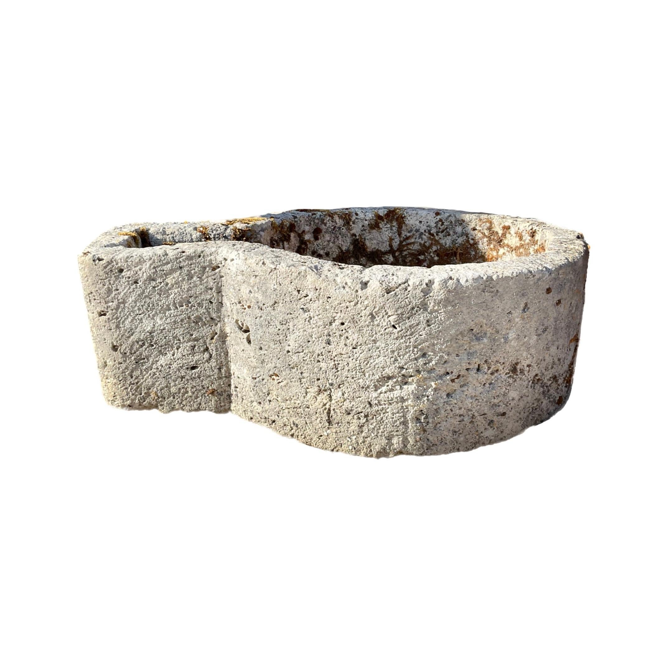This French Limestone Ham Trough, dating back to the 17th century, adds a touch of history to any space. Originally used to cure and season ham in France, it now serves as a unique planter or small birdbath. Made of durable limestone, it will bring